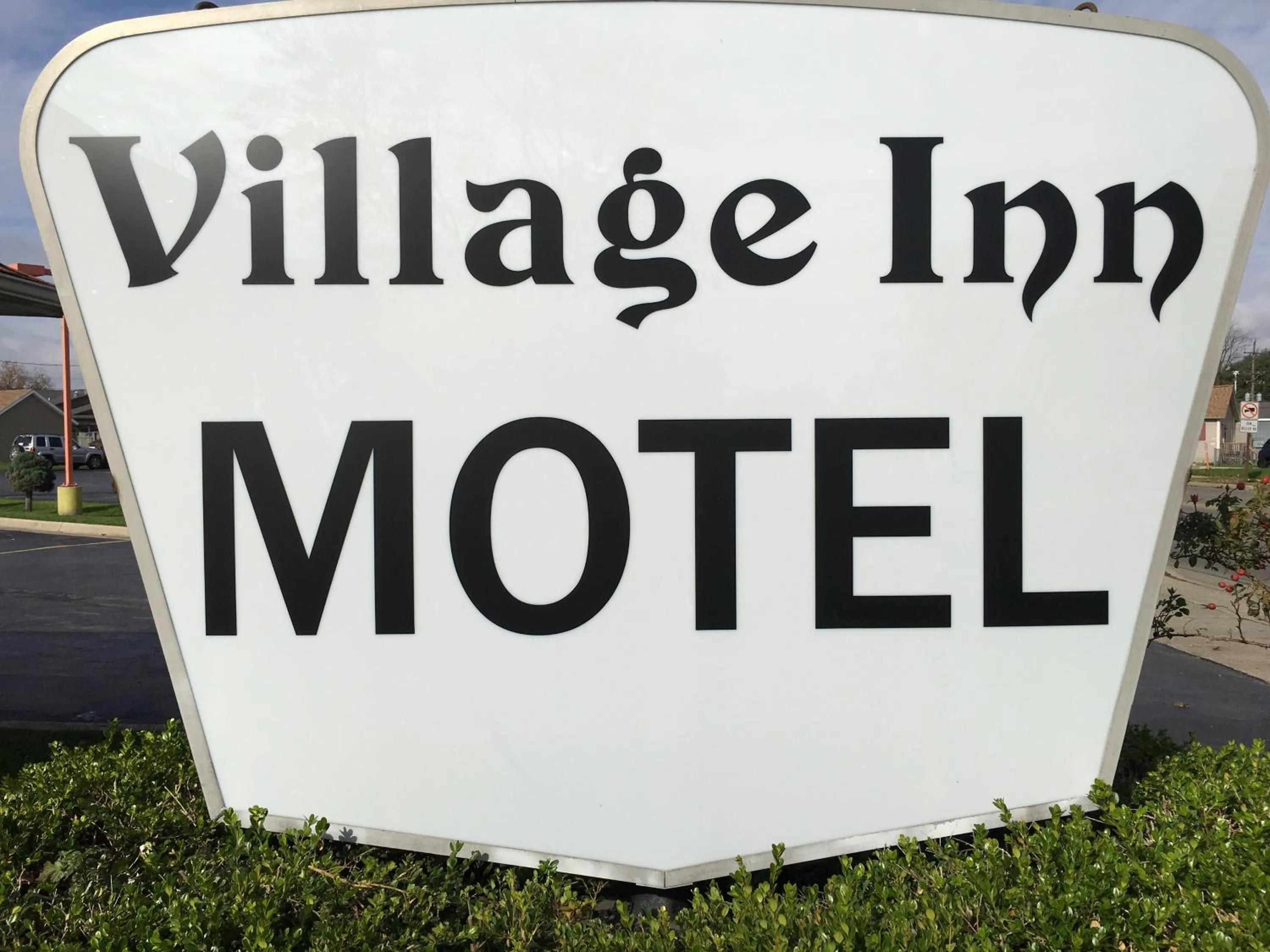 Property logo or sign in Village Inn Motel Holt