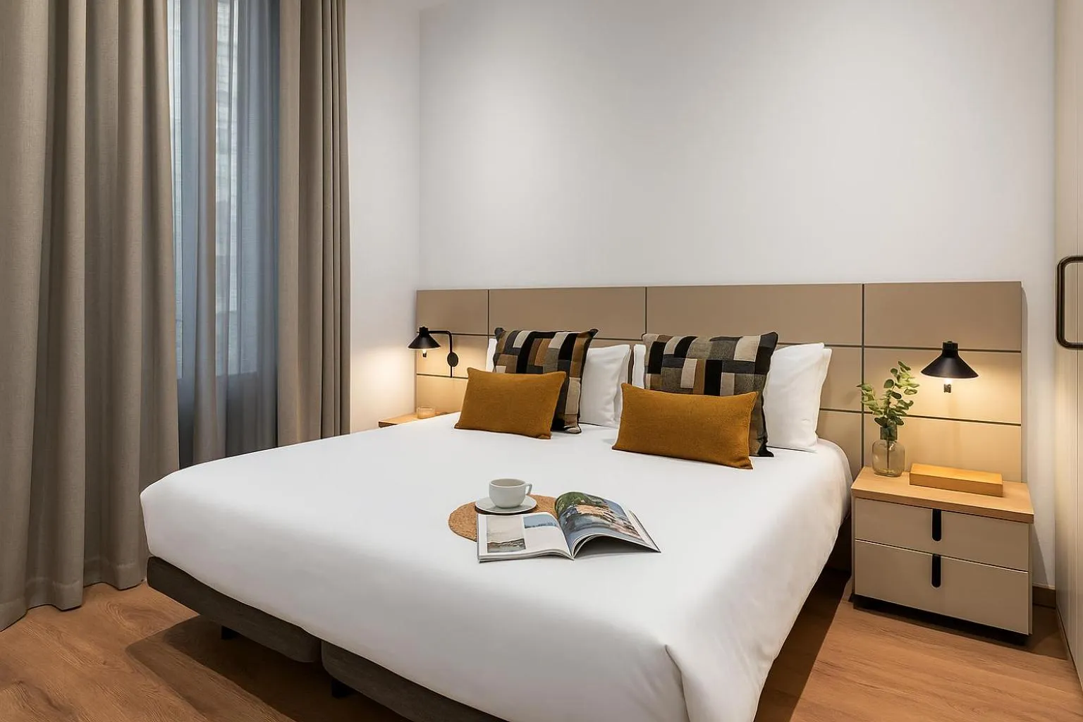 Bed in The Corner Apartments by Aspasios