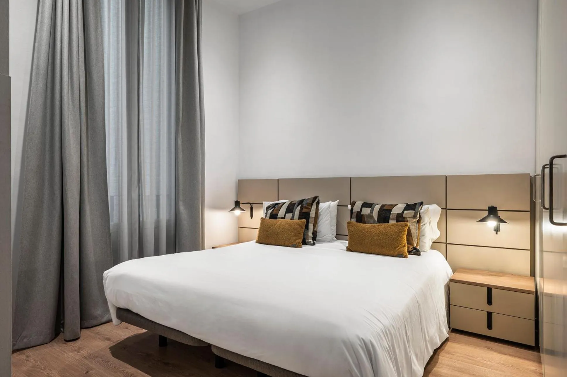 Bedroom, Bed in The Corner Apartments by Aspasios