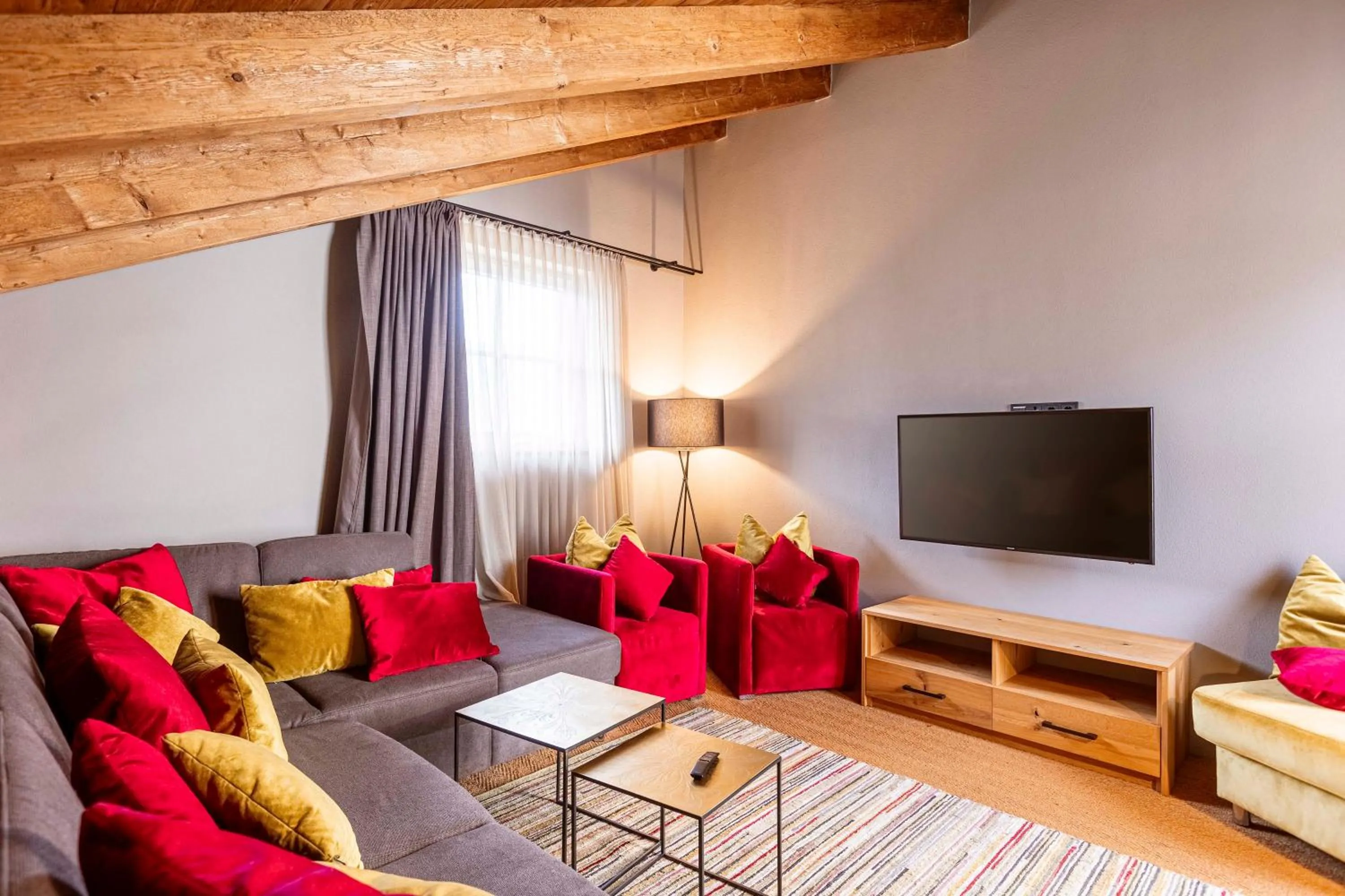 Communal lounge/ TV room in Tauernsuites Mitterwirt by ALPS RESORTS