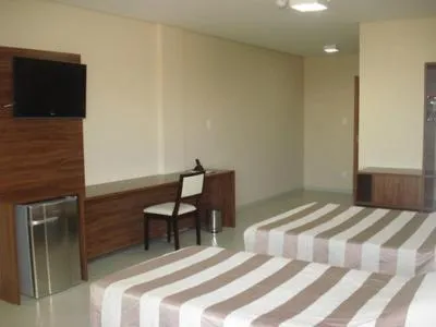 Bed in Flamboyant Suite Hotel