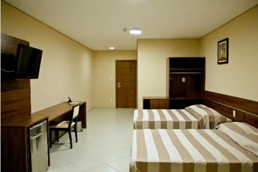 Bed in Flamboyant Suite Hotel