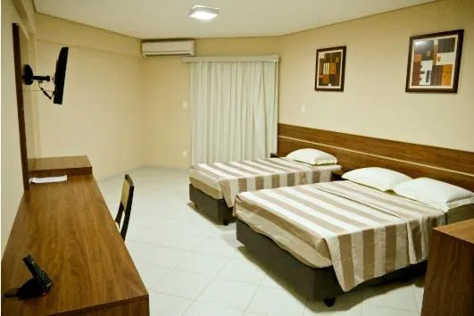 Bed in Flamboyant Suite Hotel