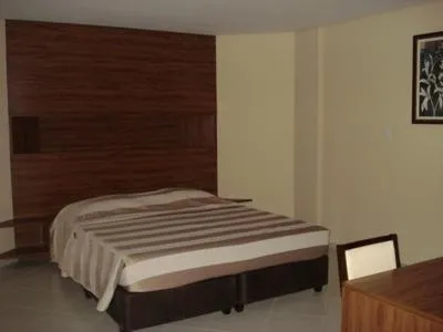 Bed in Flamboyant Suite Hotel