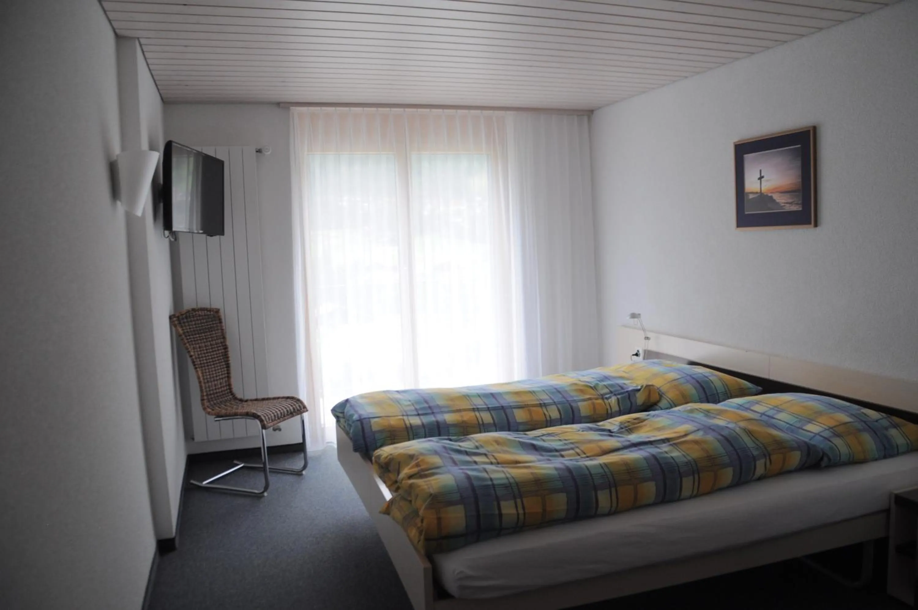 Photo of the whole room, Bed in Ferien- und Familienhotel Alpina Adelboden