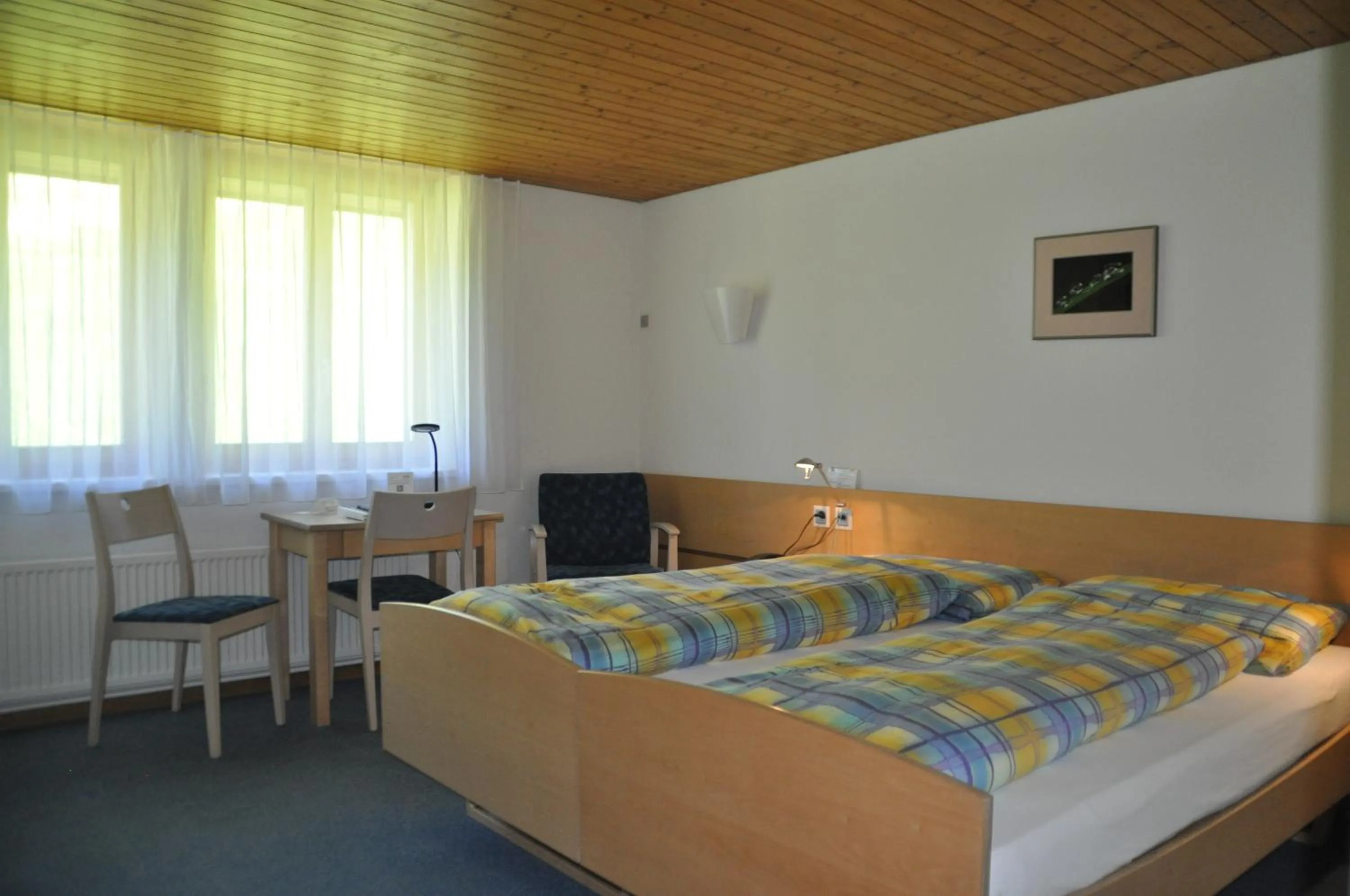 Photo of the whole room, Bed in Ferien- und Familienhotel Alpina Adelboden