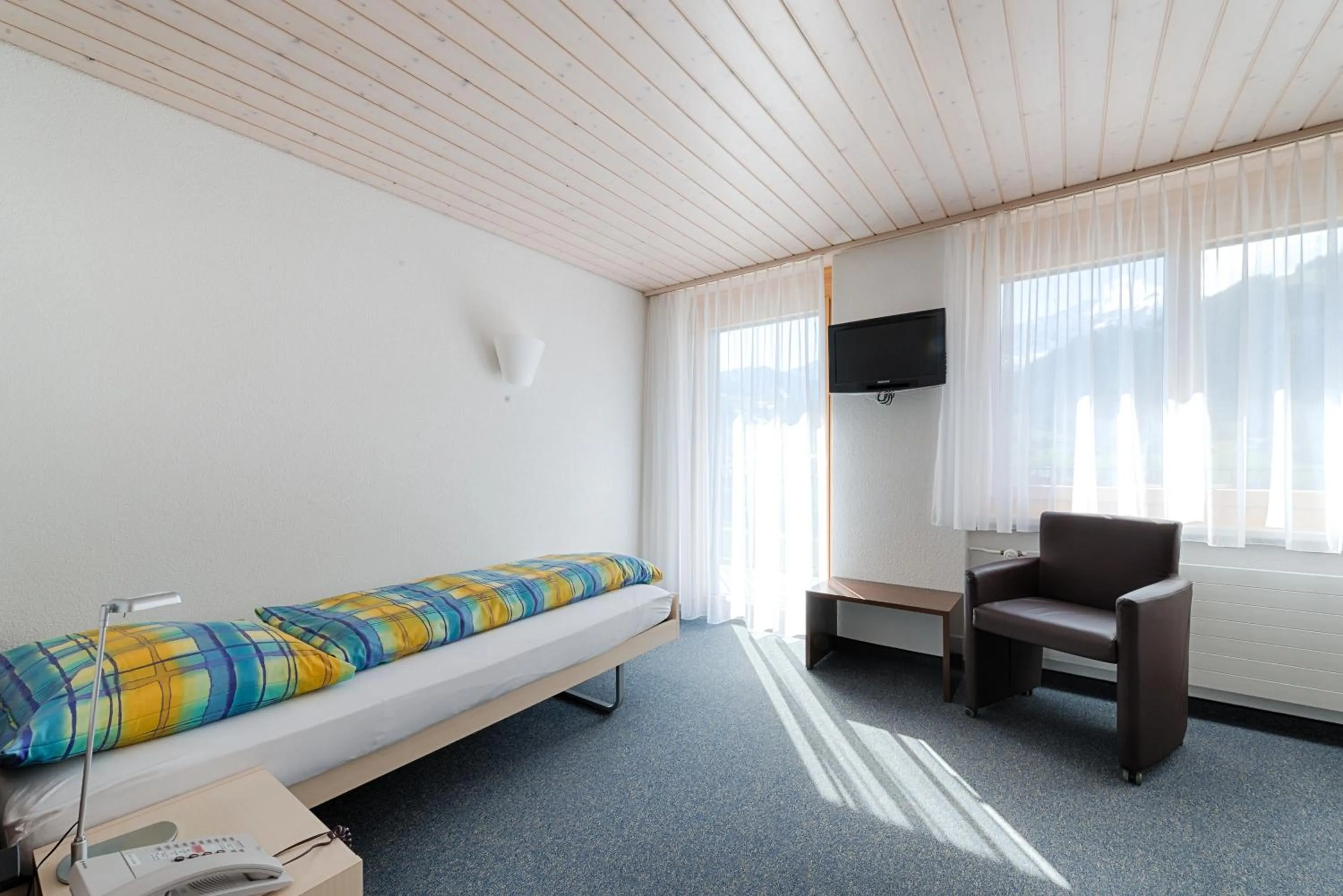 Photo of the whole room, Bed in Ferien- und Familienhotel Alpina Adelboden