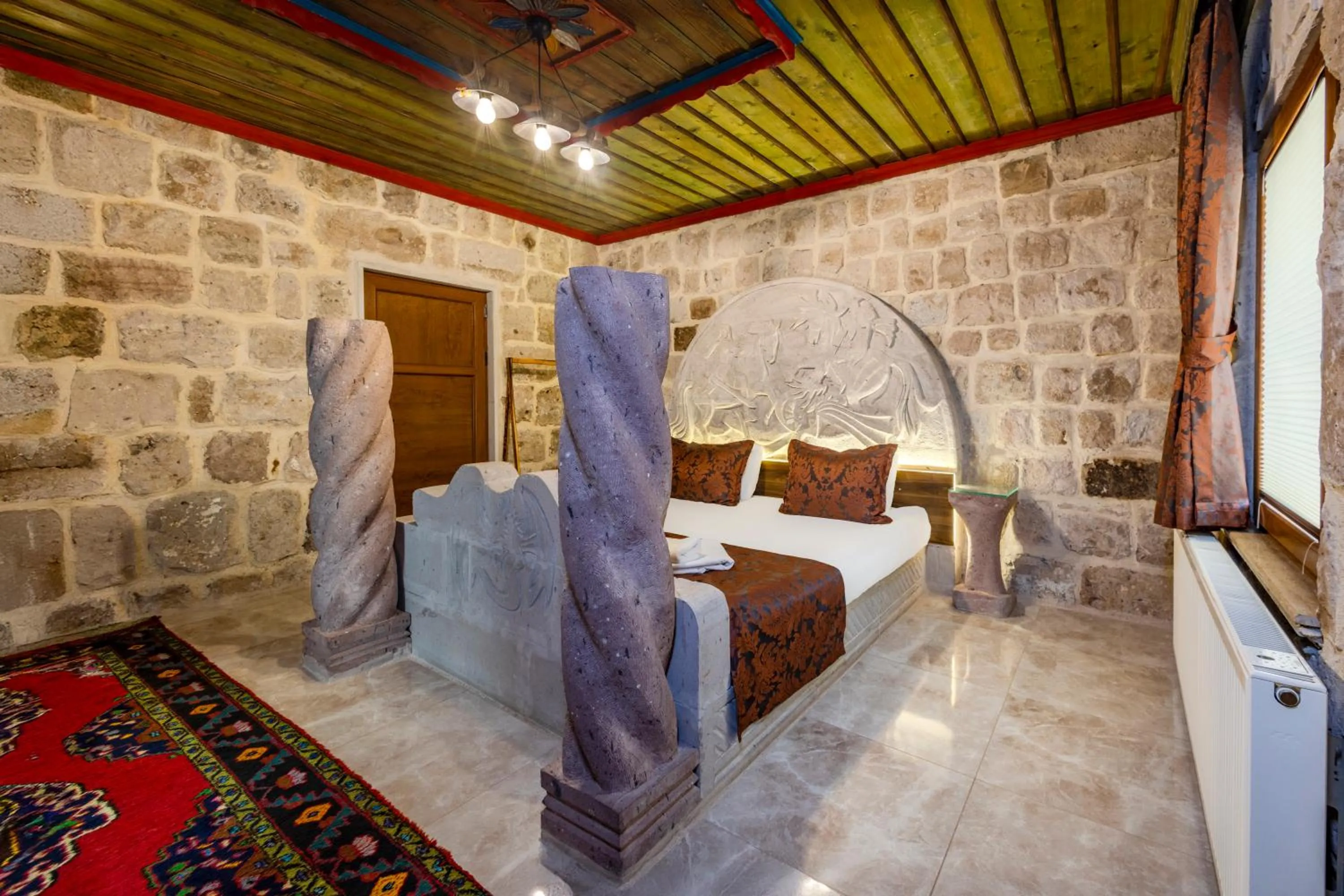 Bed in Kayatas Cave Suites