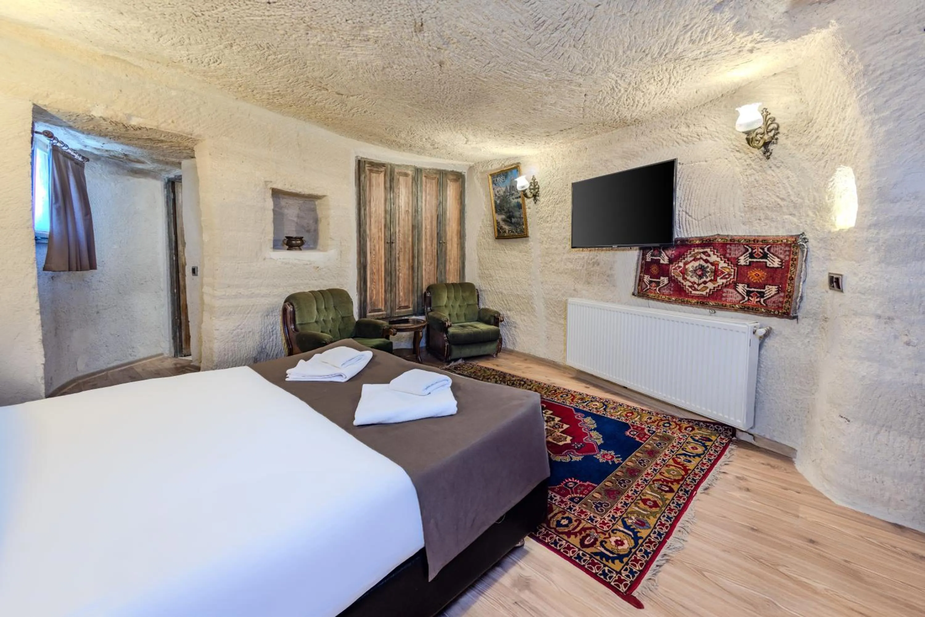 Bed in Kayatas Cave Suites