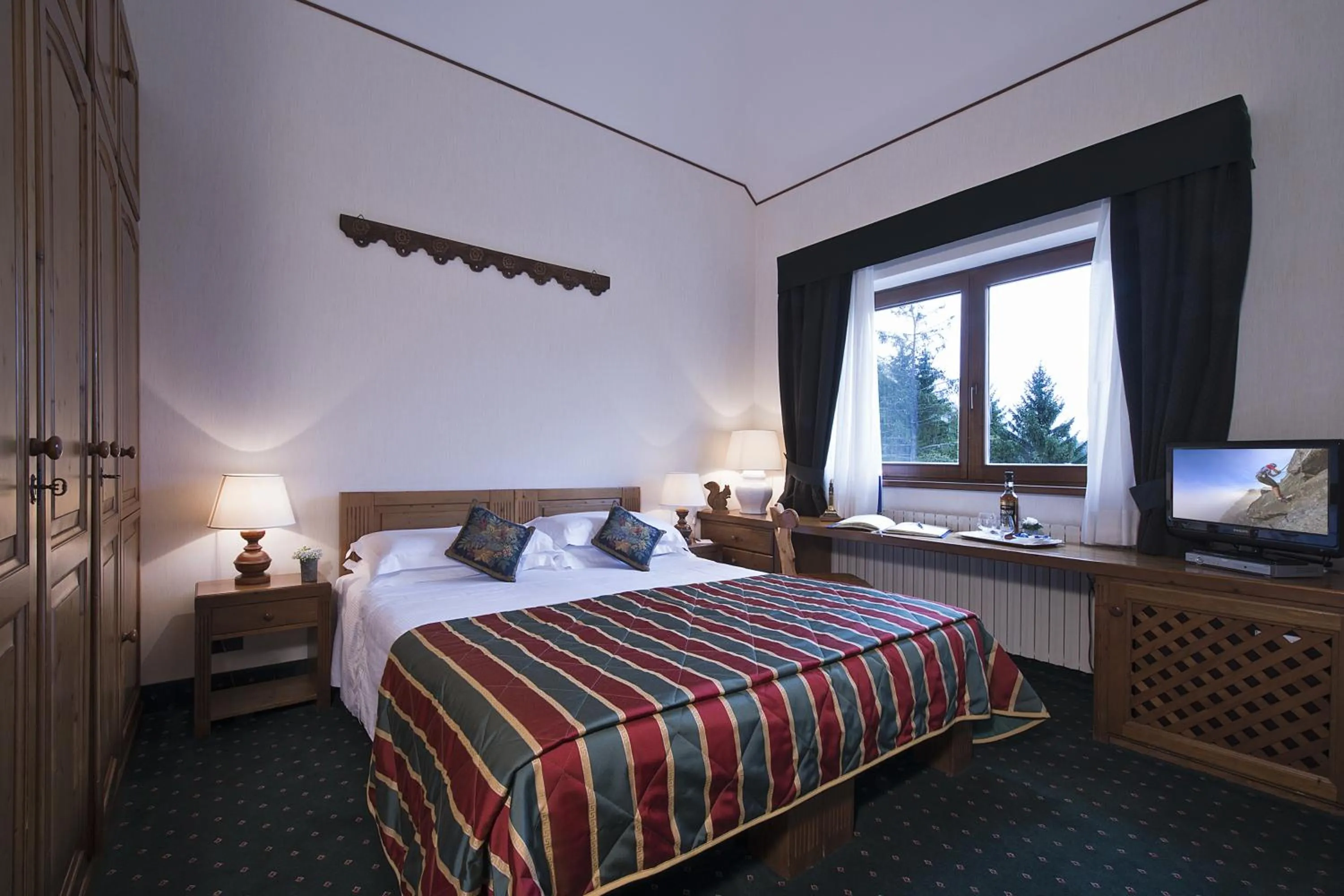 Photo of the whole room, Bed in Boutique Hotel Villa Blu Cortina D'Ampezzo