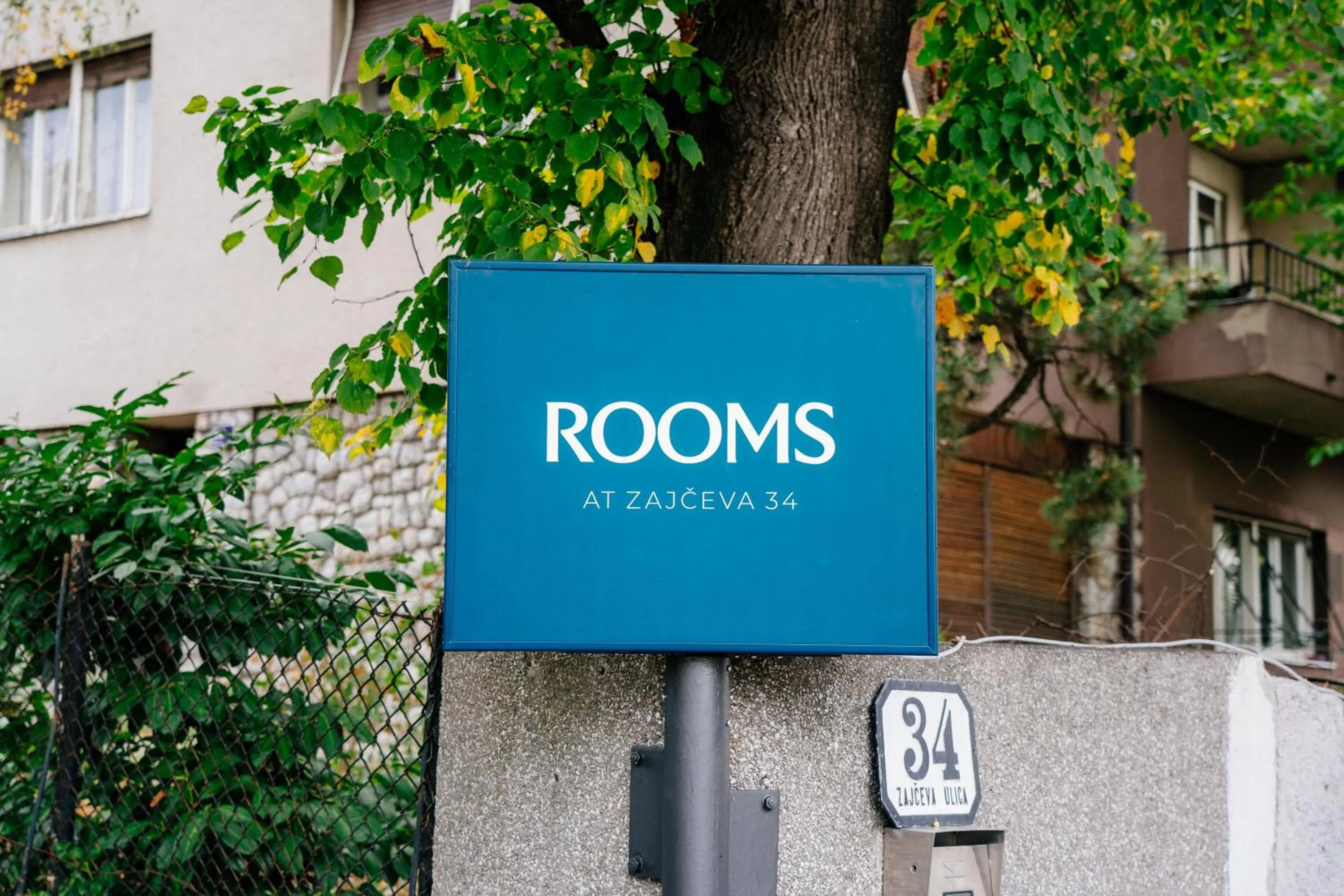 Property logo or sign in Rooms at Zajčeva 34