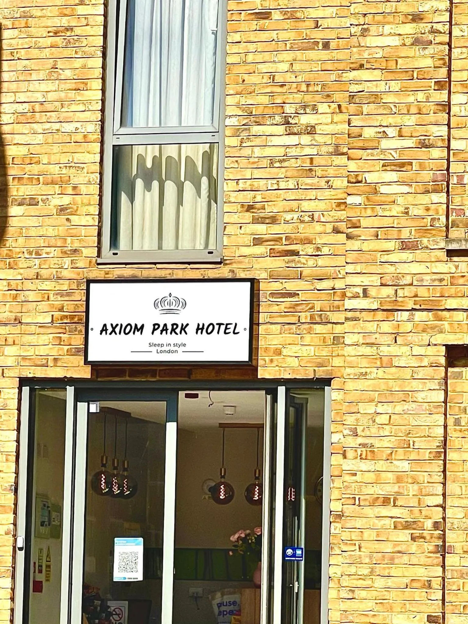 Property logo or sign in Axiom Park Hotel