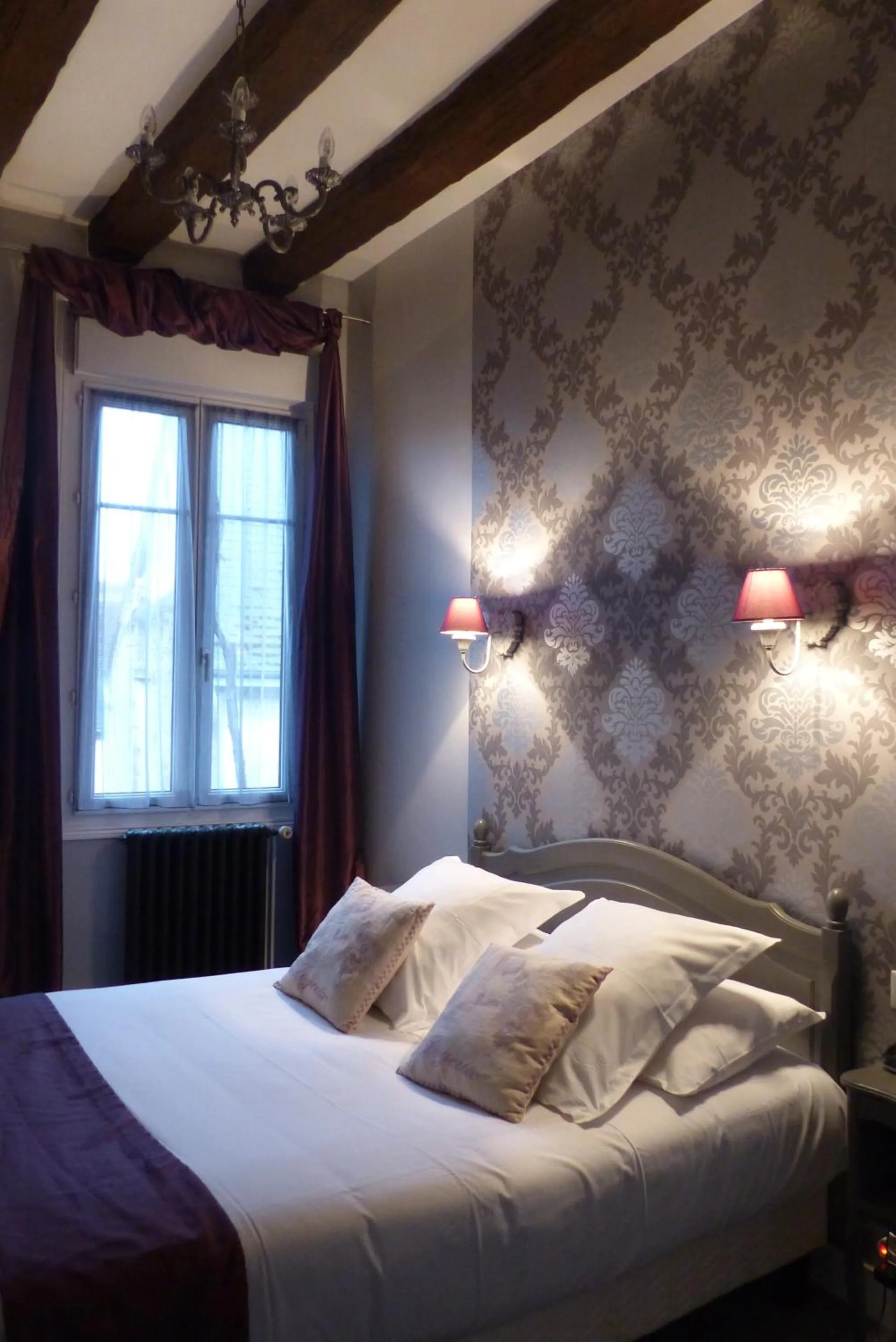 Bed in Logis Hotel Restaurant Le Cheval Blanc