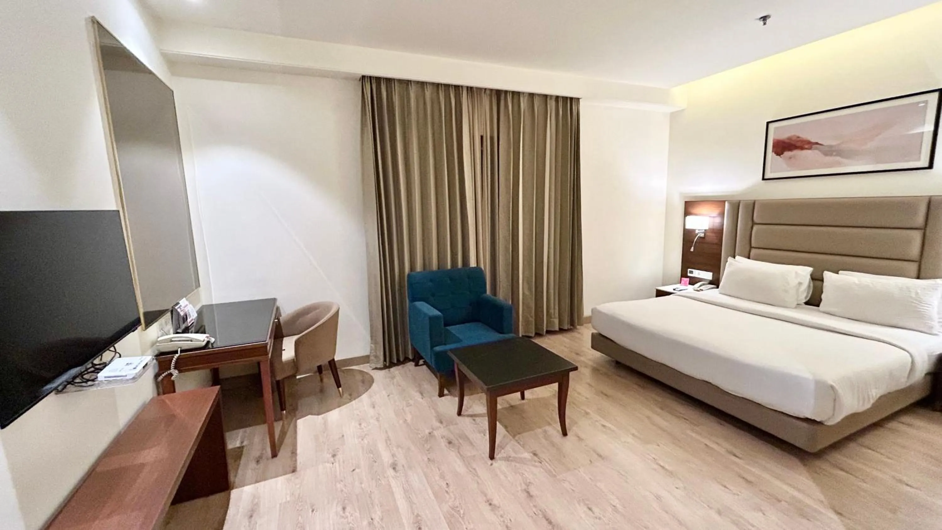 Communal lounge/ TV room, Bed in Ramada by Wyndham Jalandhar City Center