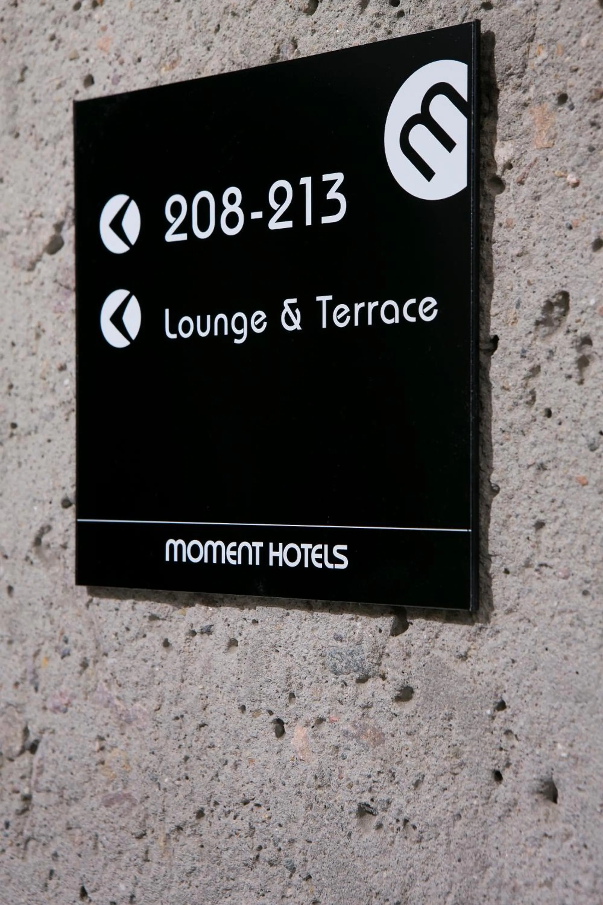 Property logo or sign in Moment Hotels