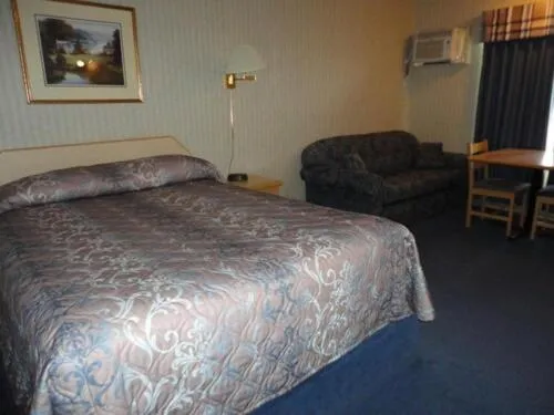 Bed in Perfect Inns & Suites