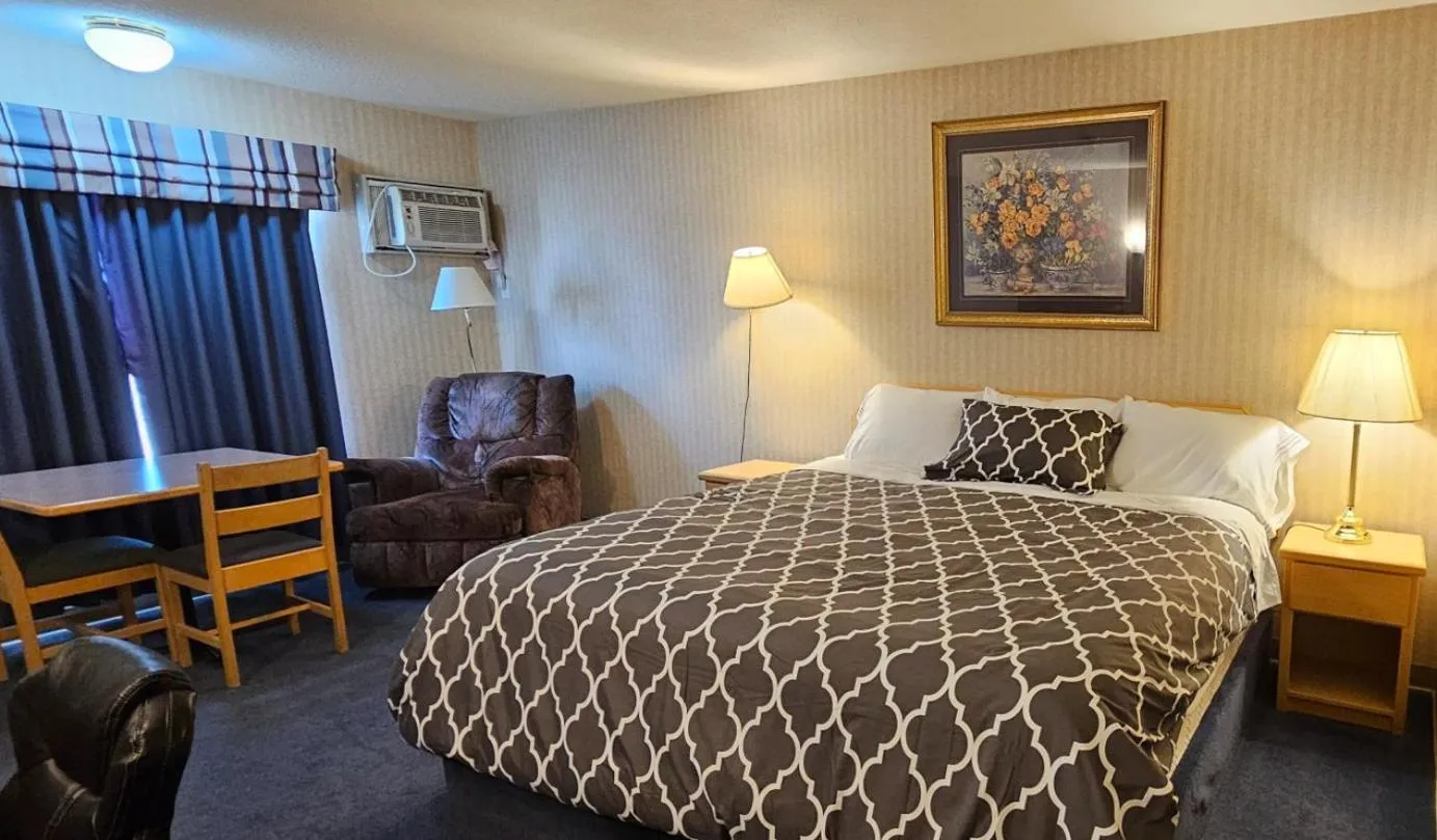 Bed in Perfect Inns & Suites