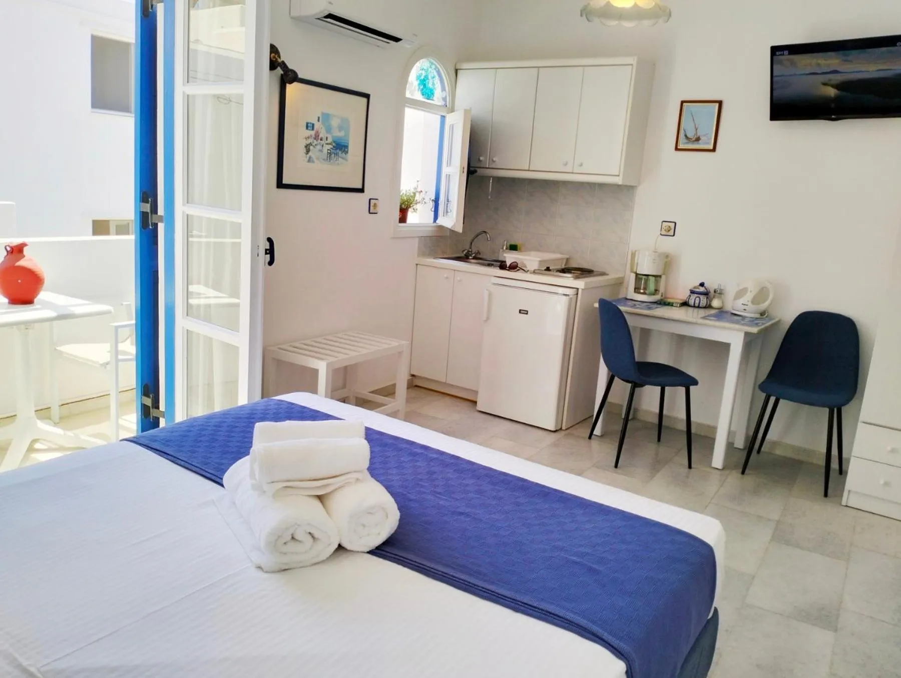 Kitchen or kitchenette, Bed in Nostos Studios at Saint George beach Agios Georgios Chora Naxos town