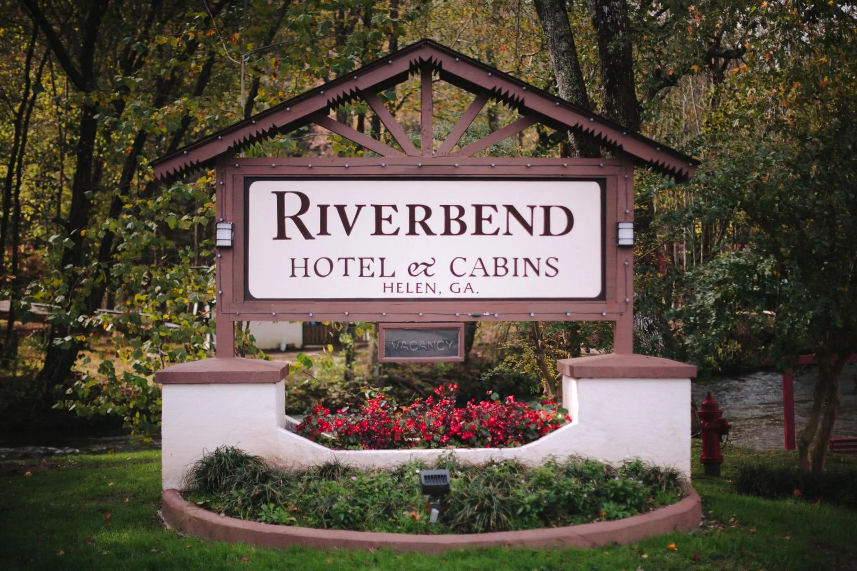 Property logo or sign in Riverbend Motel & Cabins