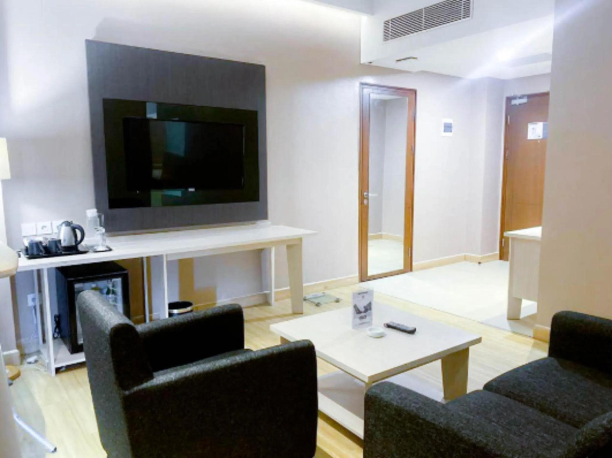 Seating area in Harper Palembang by ASTON