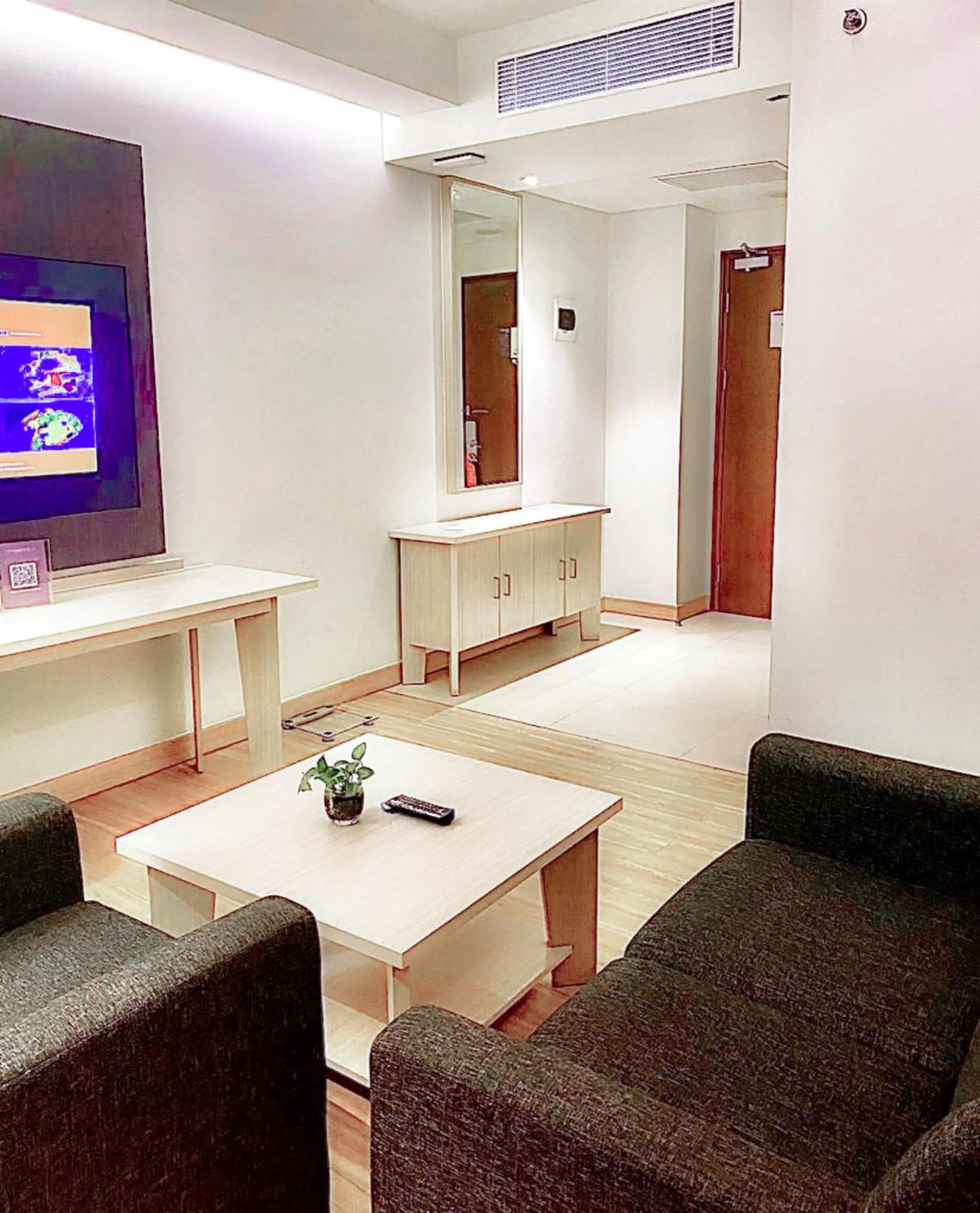 Seating area in Harper Palembang by ASTON