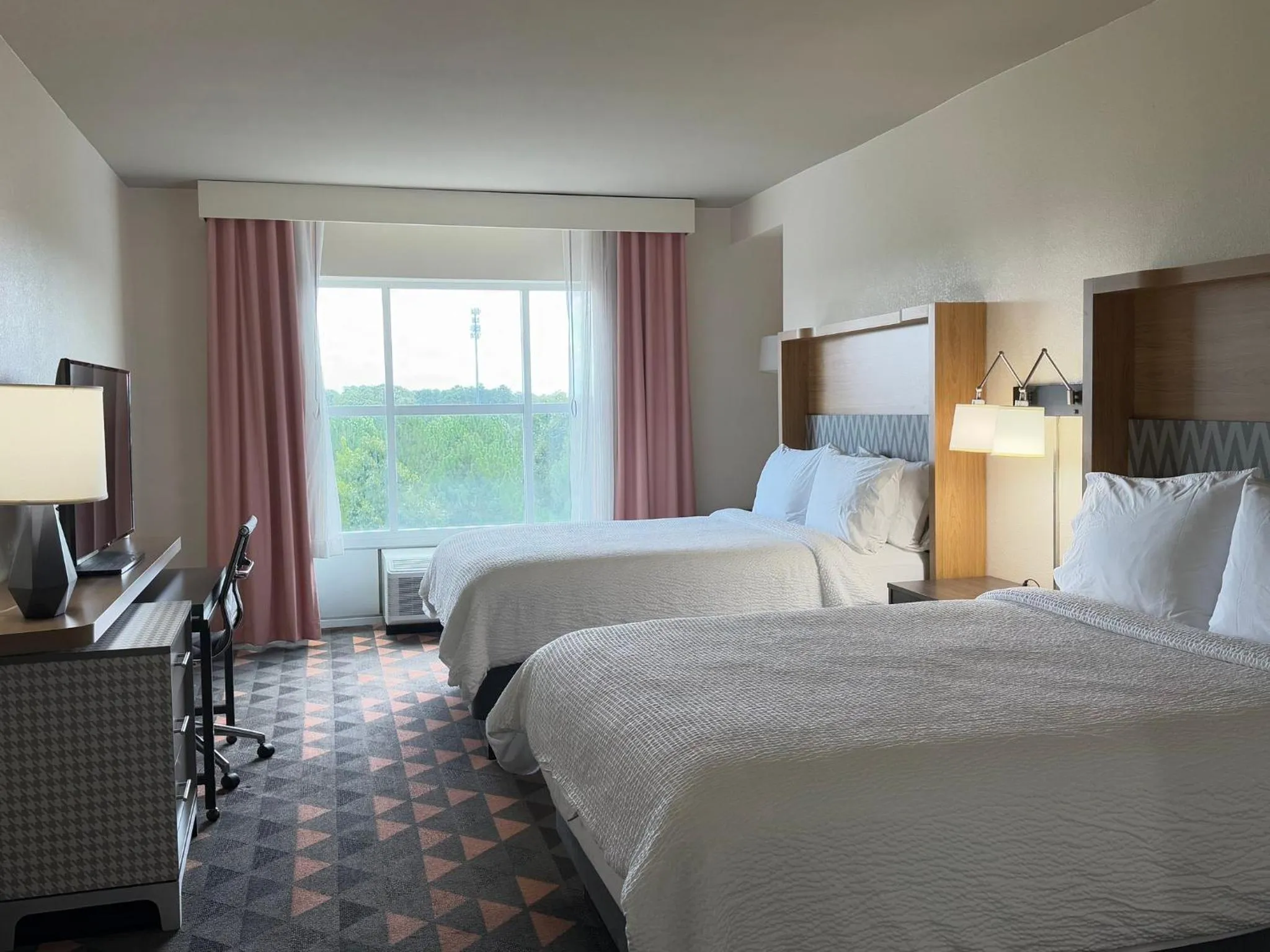 Photo of the whole room, Bed in Holiday Inn & Suites - Fayetteville W-Fort Bragg Area by IHG