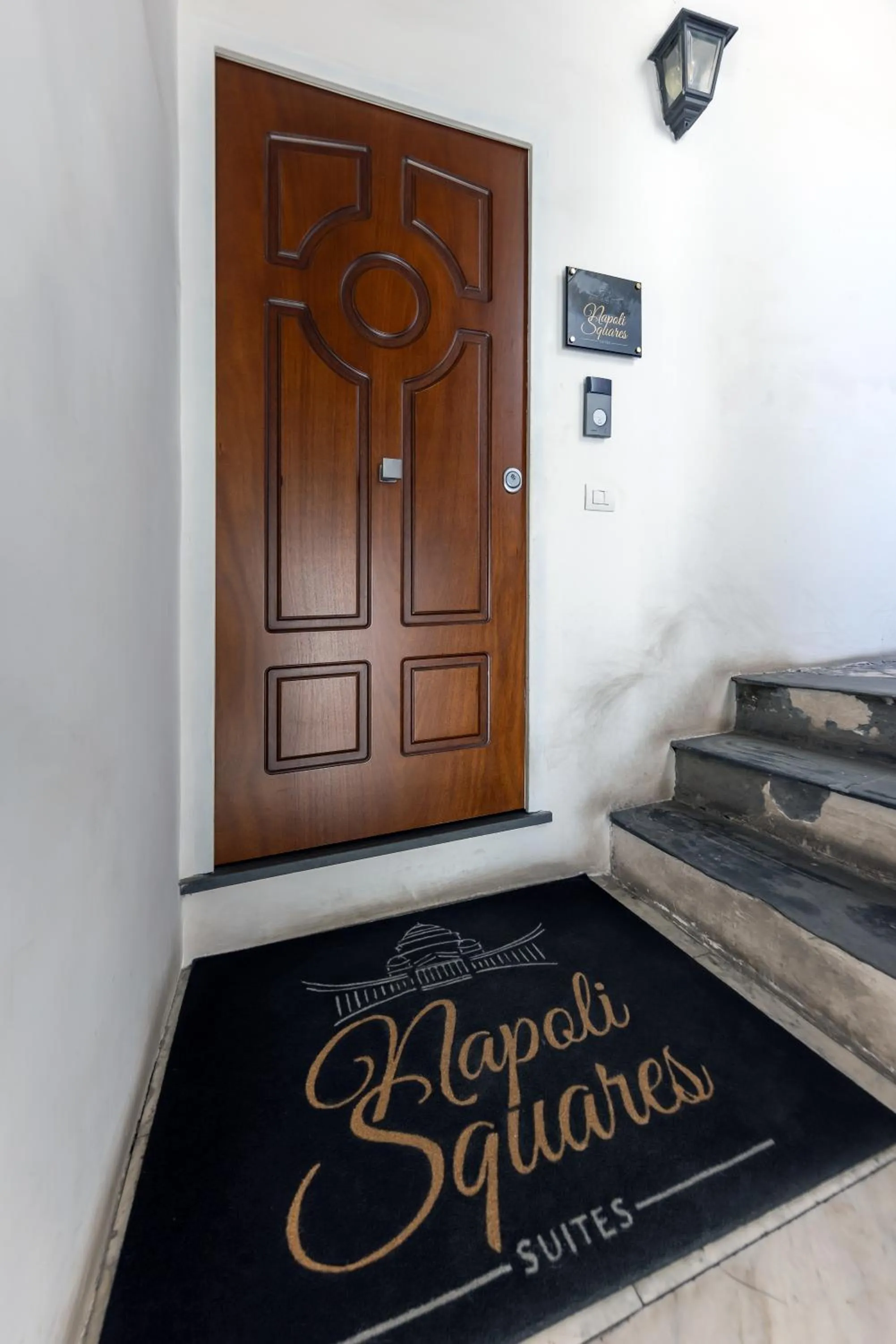 Property logo or sign in Napoli Squares Suites