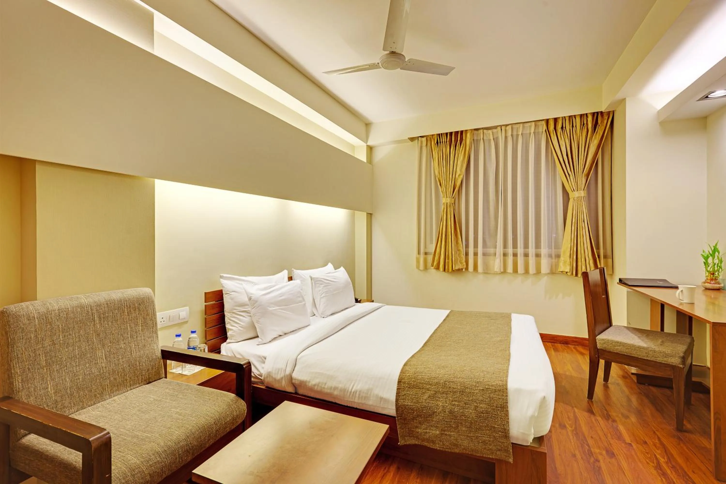 Seating area, Bed in Whispering Palms Hotel Jaipur