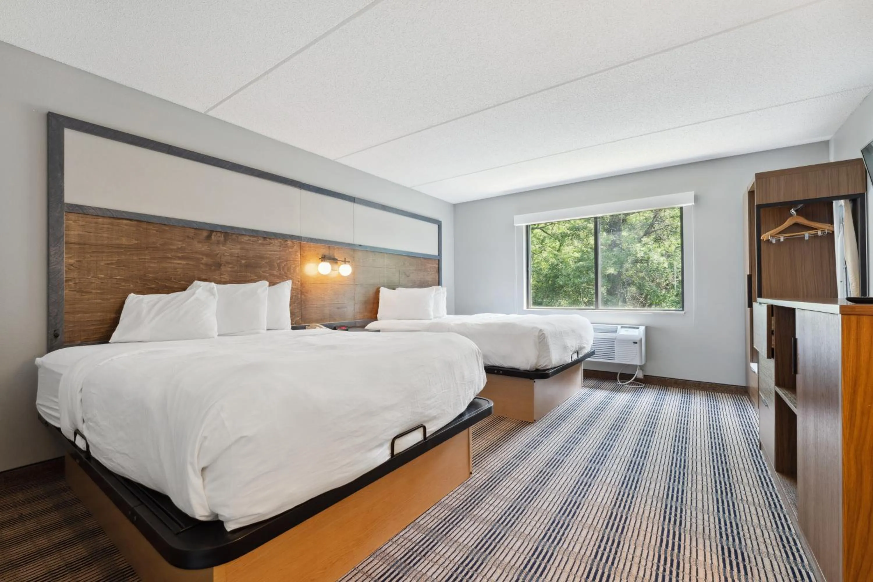 Bed in AmericInn by Wyndham Wisconsin Dells