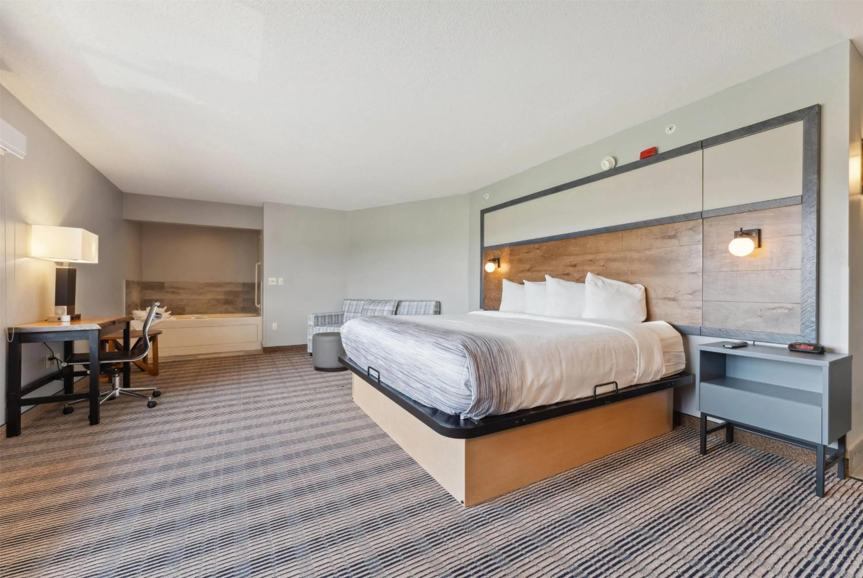 Bed in AmericInn by Wyndham Wisconsin Dells