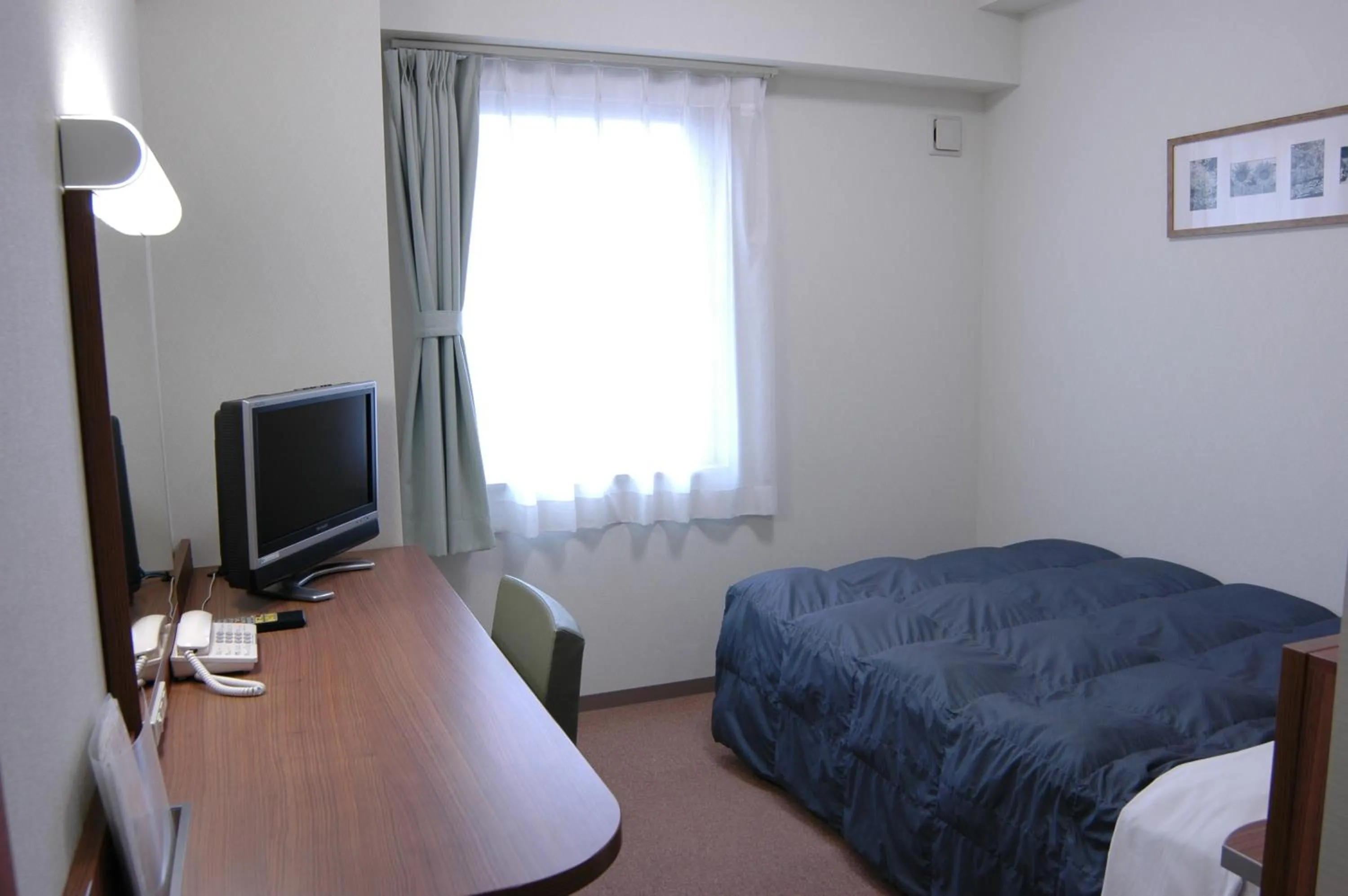 Bed in Hotel Econo Tsu Station