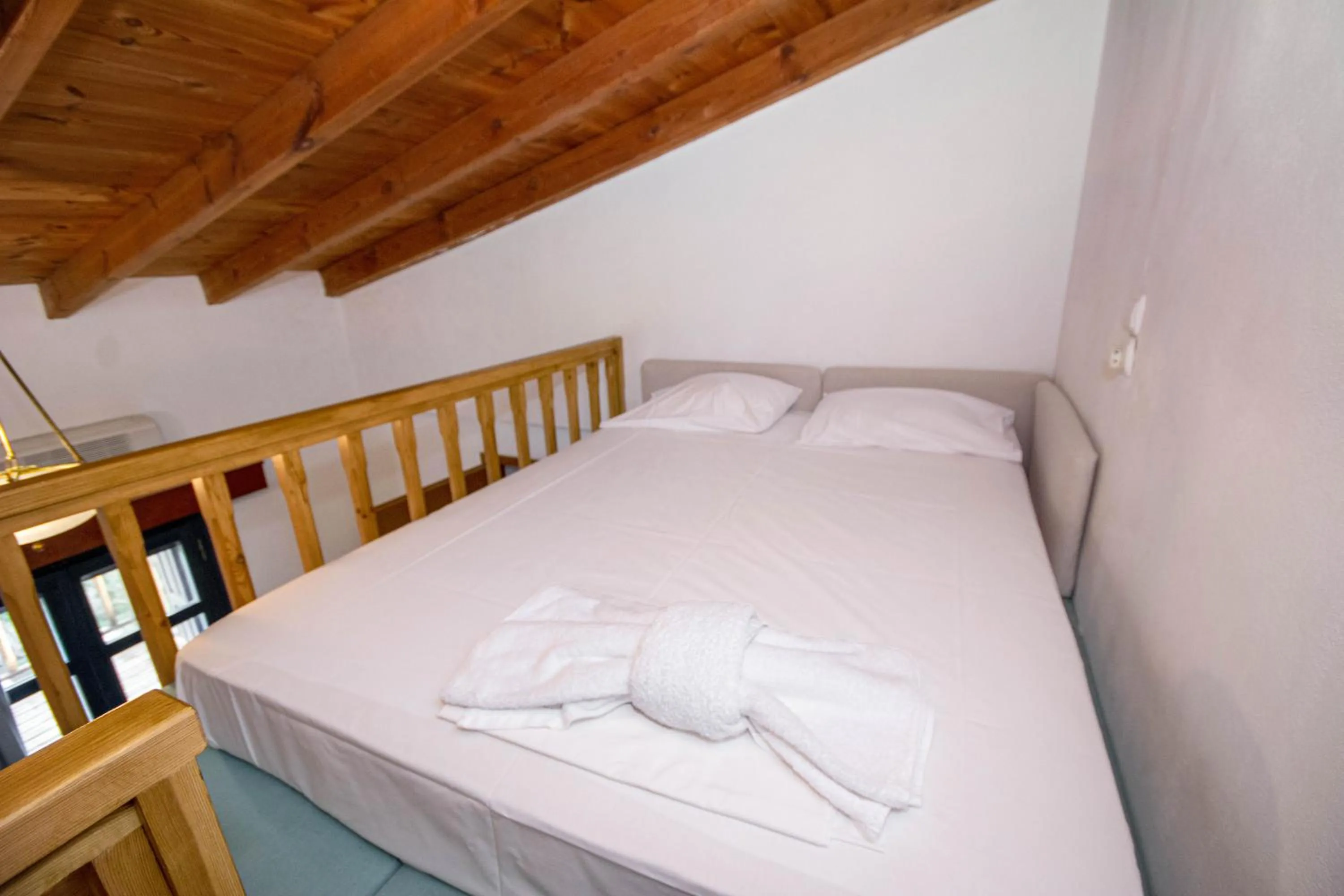 Bed in Triton Authentic Cretan Hotel