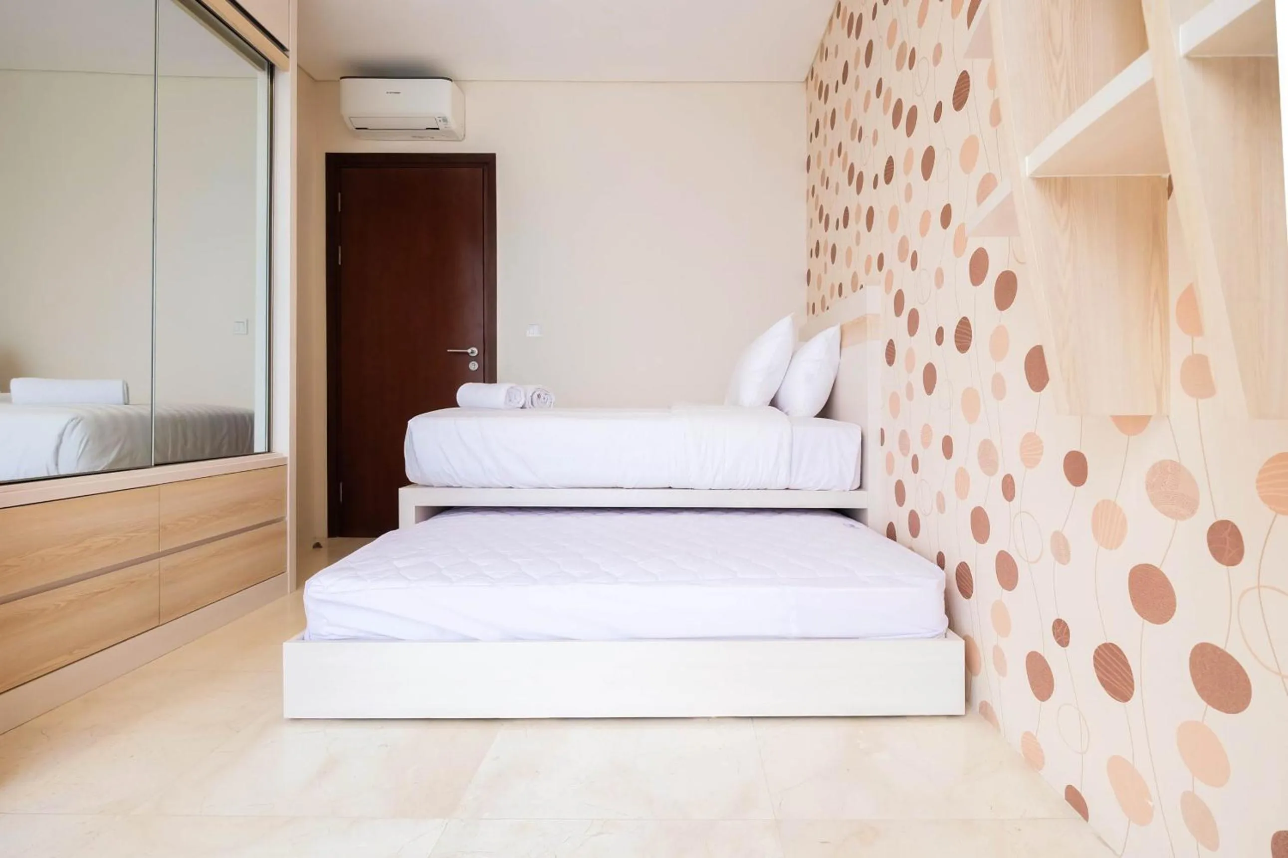 Bed in 2BR Cozy and Modern L'Avenue Apartment By Travelio