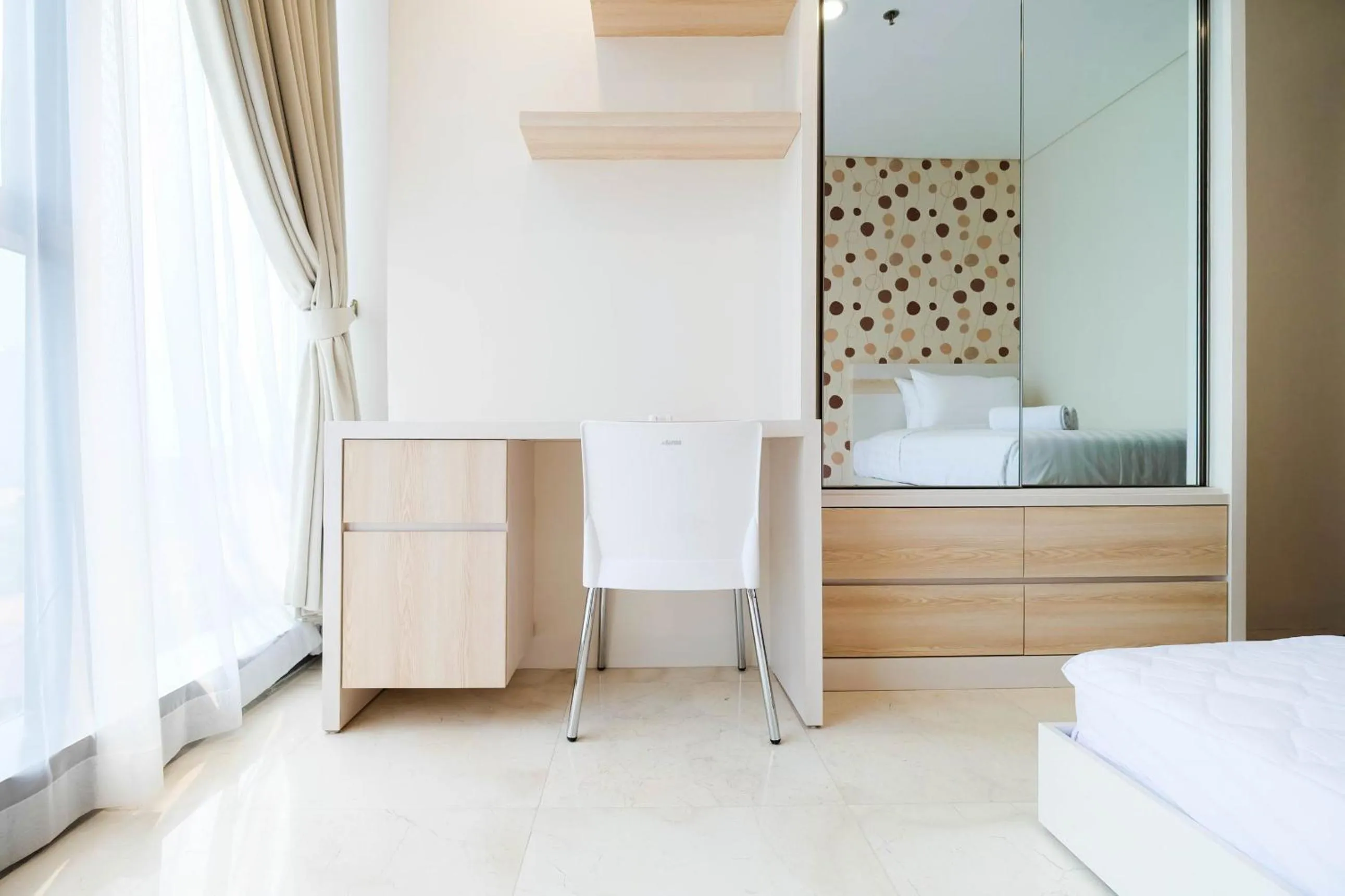 Bed in 2BR Cozy and Modern L'Avenue Apartment By Travelio