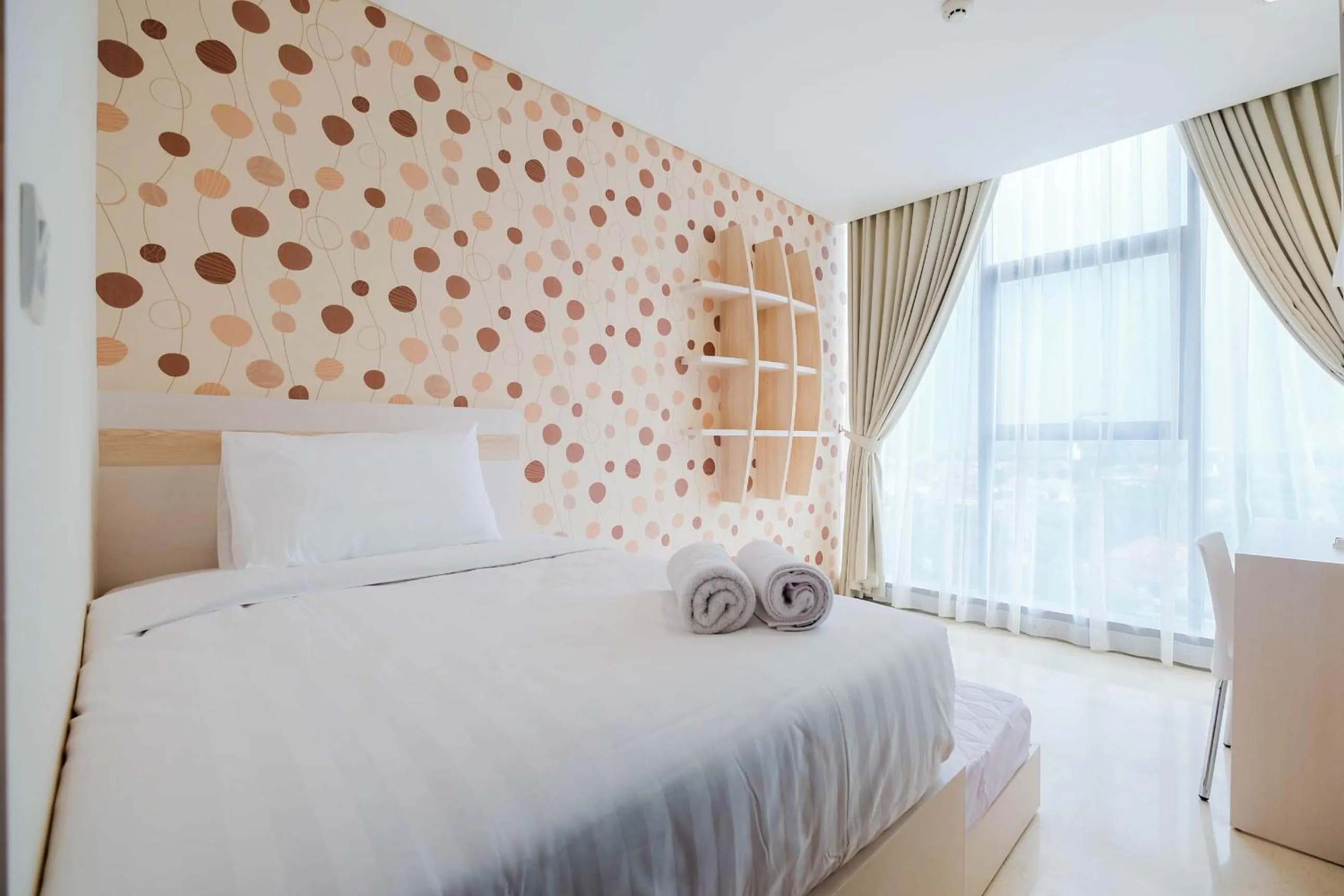 Bed in 2BR Cozy and Modern L'Avenue Apartment By Travelio