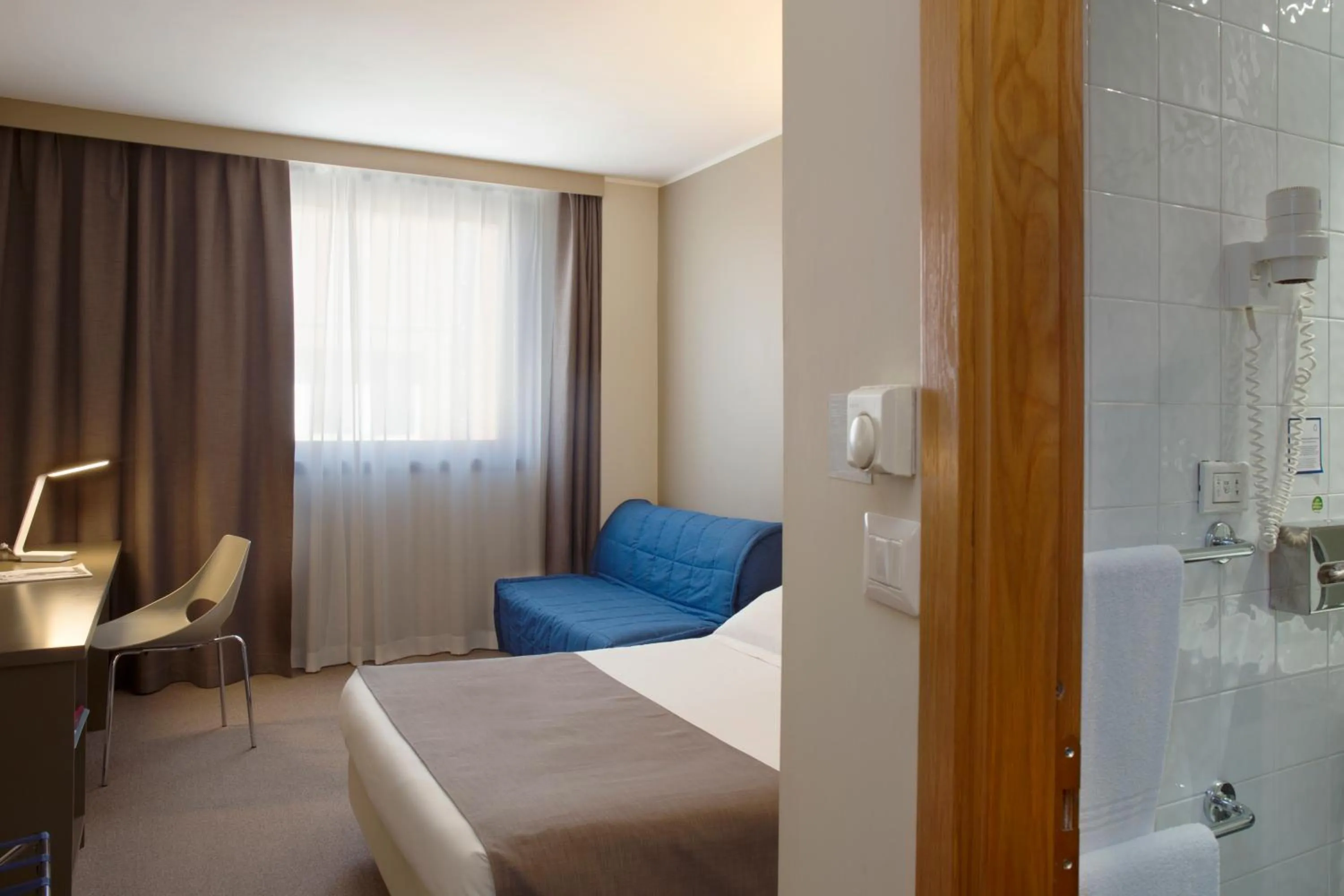 Bed in City Hotel & Suites