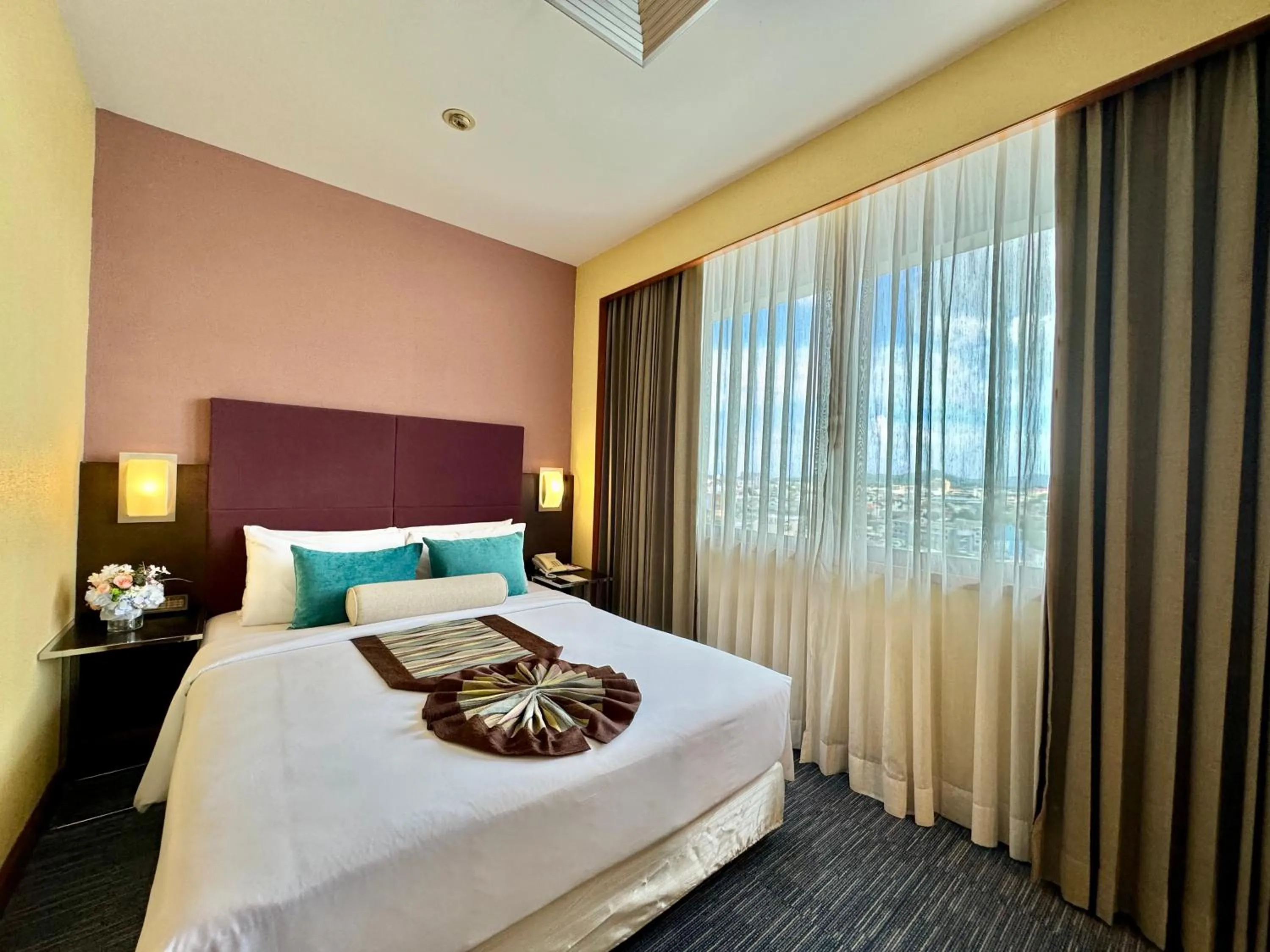 Bed in Phuket Merlin Hotel