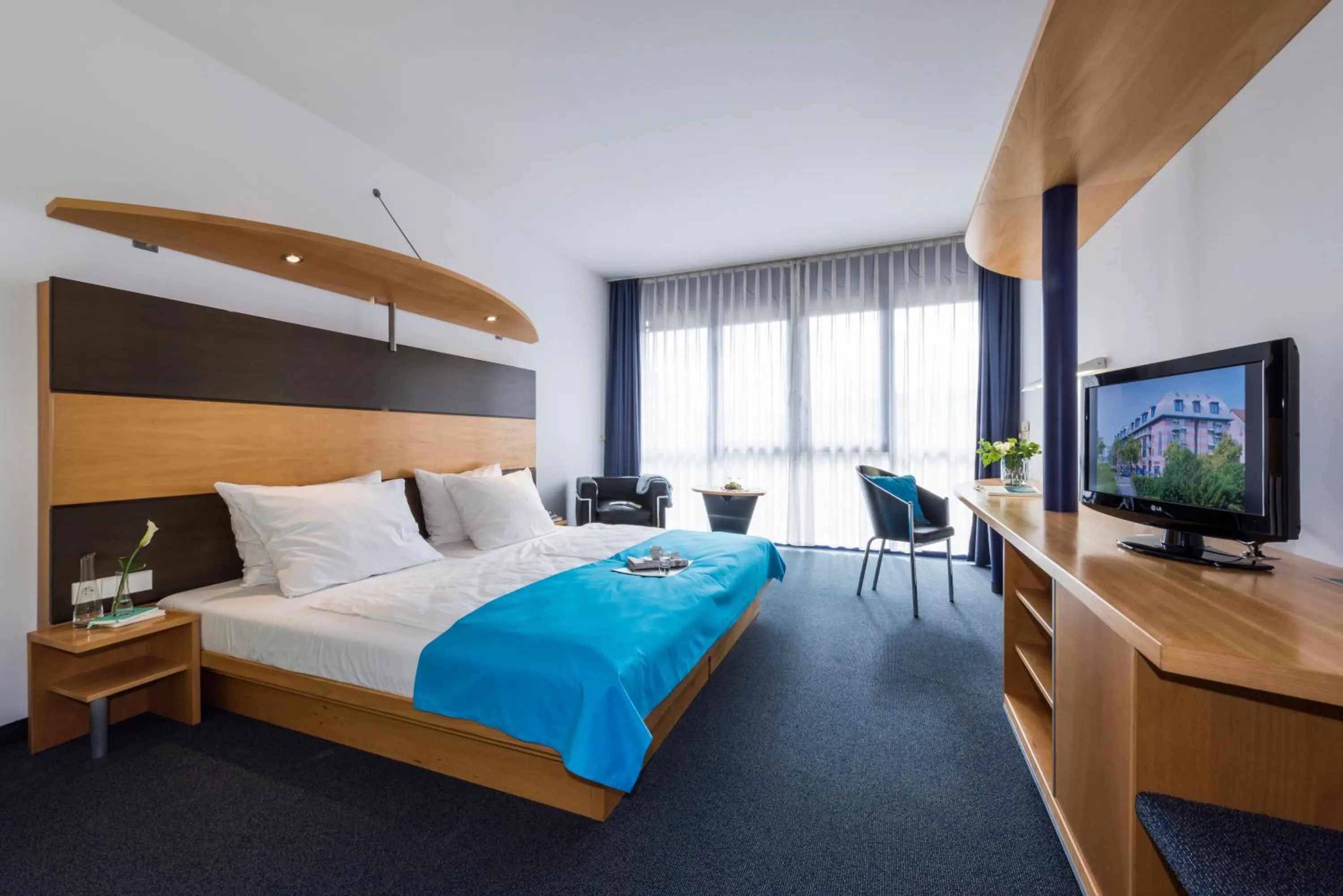 Photo of the whole room, Bed in SEEhotel Friedrichshafen