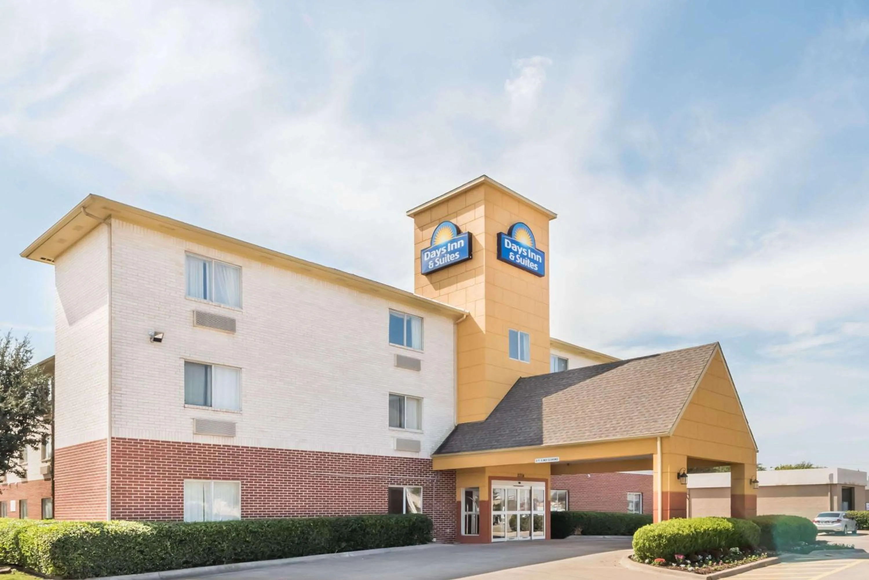 Property building in Days Inn & Suites by Wyndham Dallas