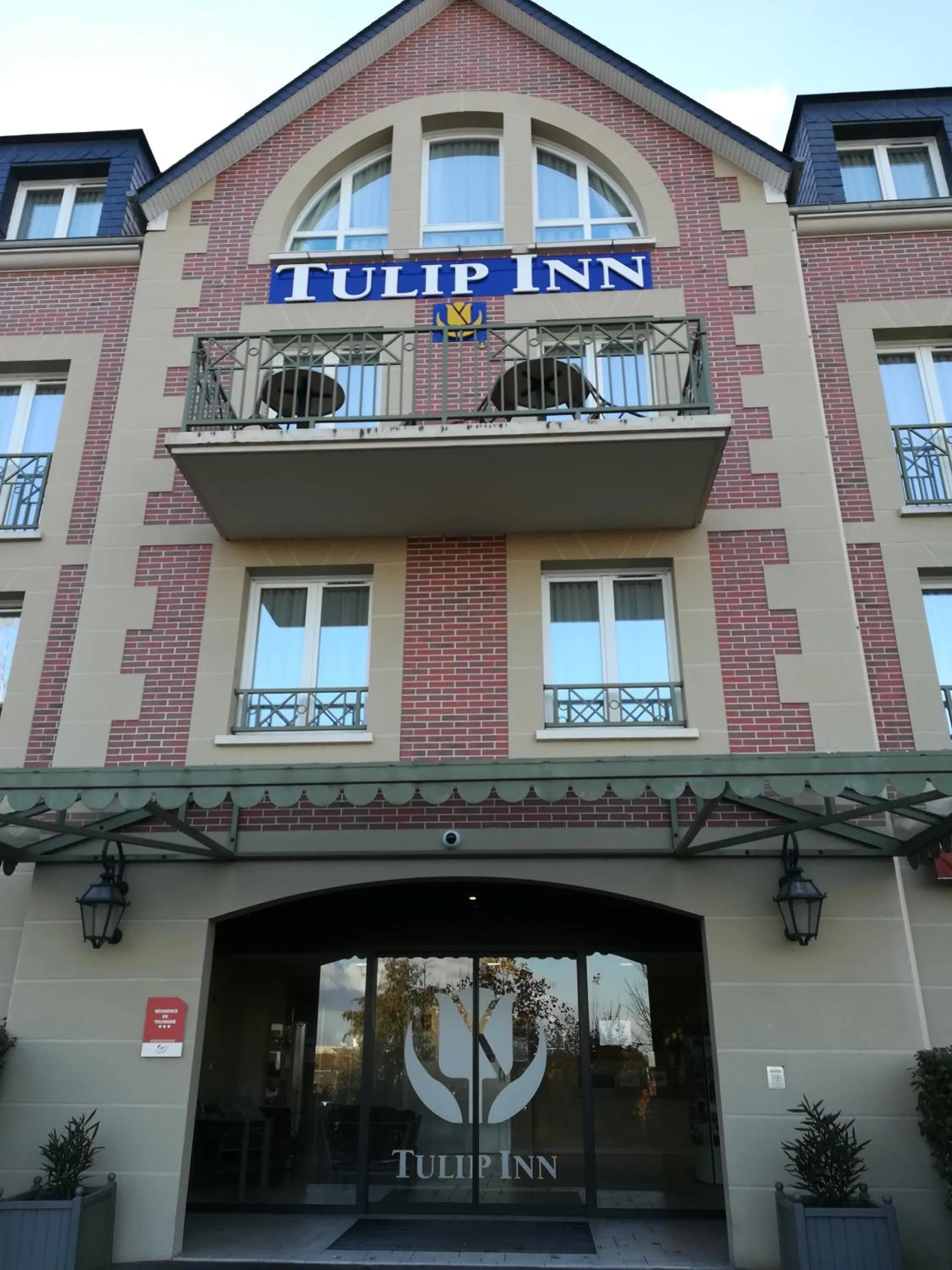 Property logo or sign in Tulip Inn Honfleur Residence & Spa