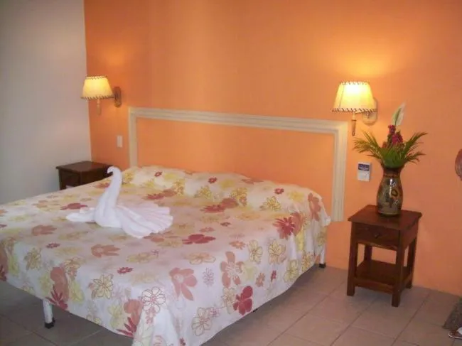 Bed in Hotel y Suites Corita