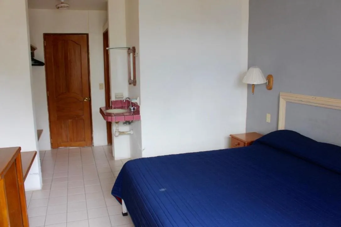 Bed in Hotel y Suites Corita