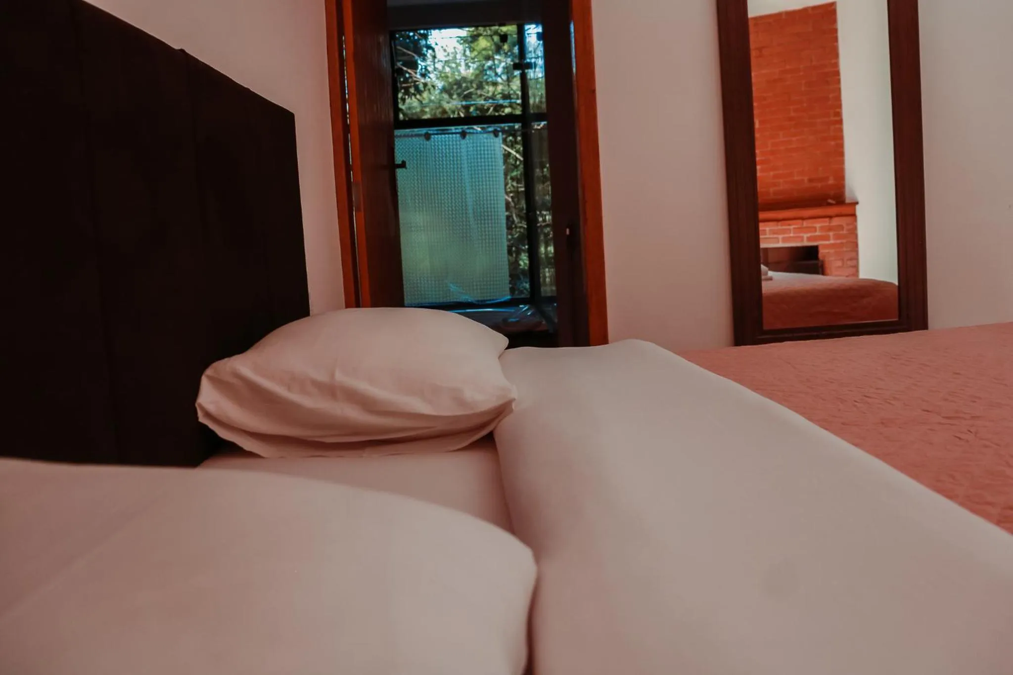 Bed in Pousada Mirante do Penedo