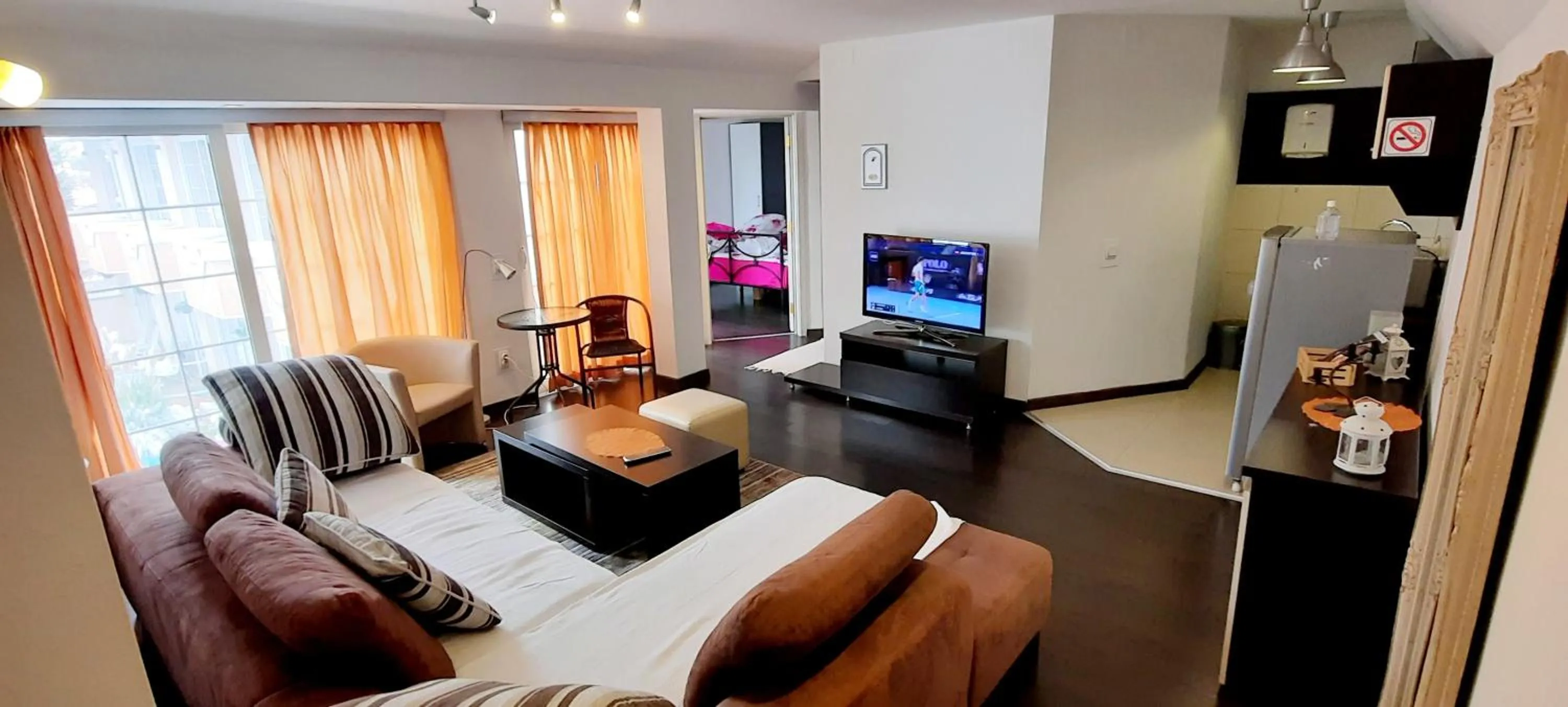 Seating area in Aloha Apartments with pool