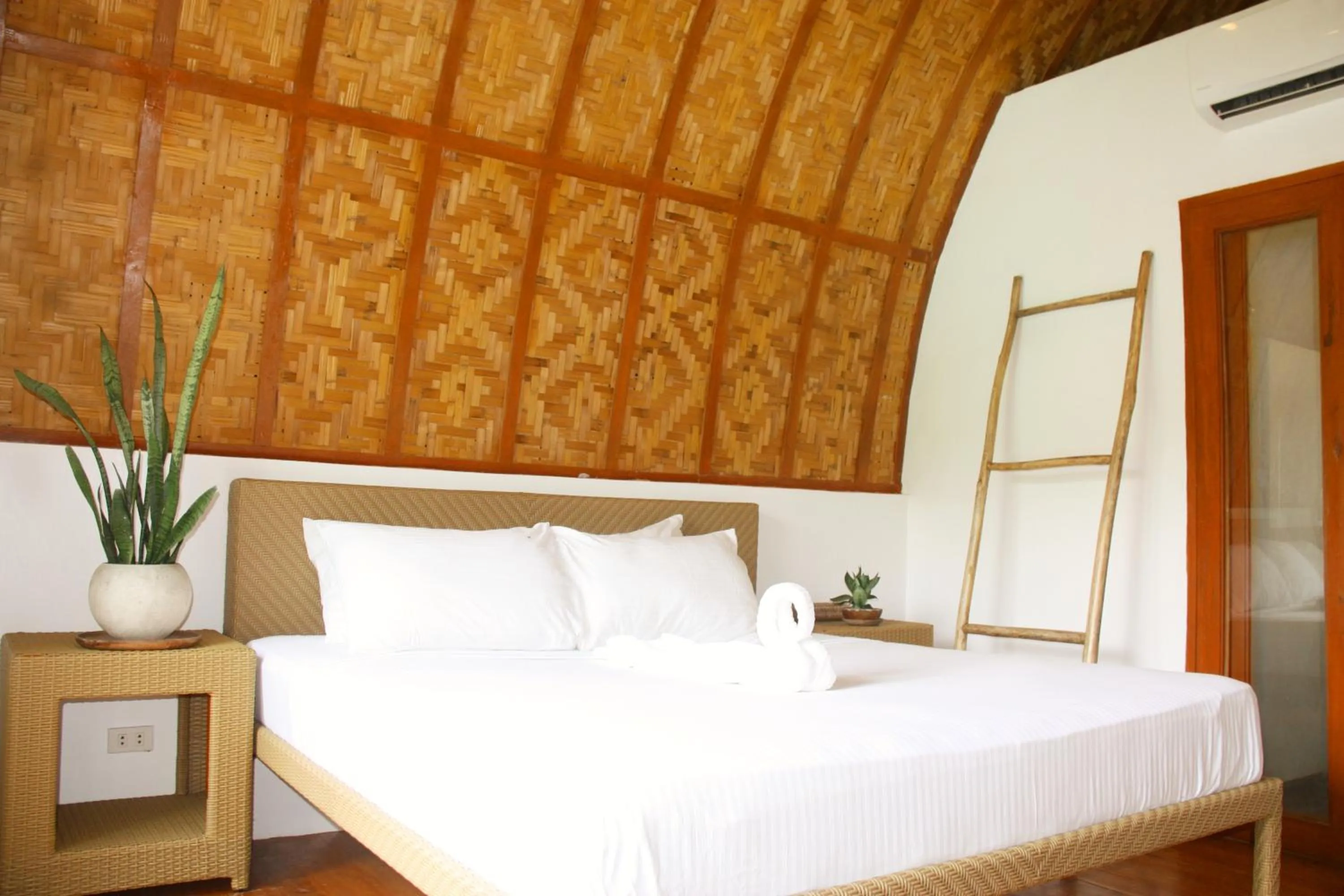 Bed in Tropical Temple Siargao Resort