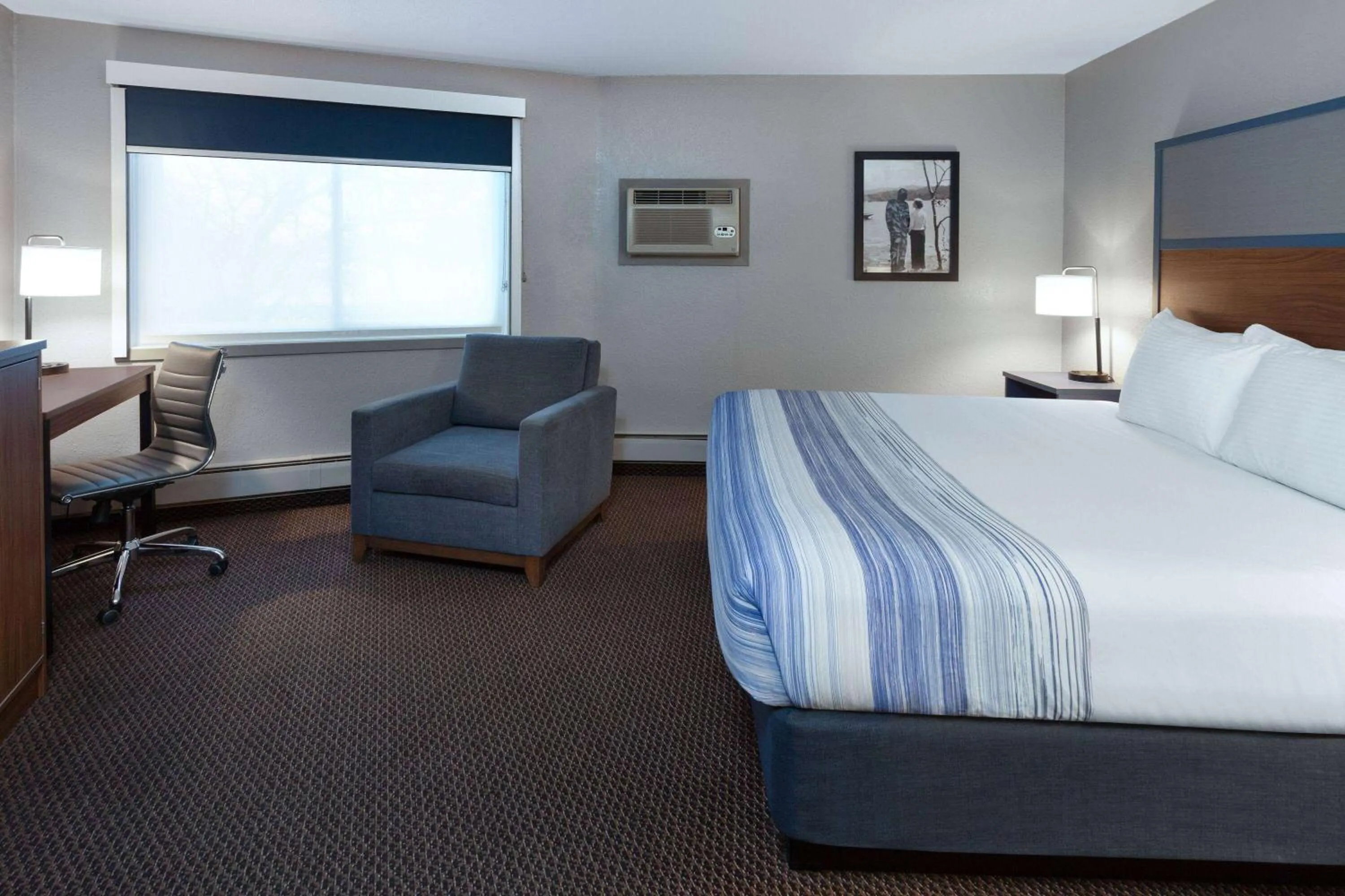Bed in AmericInn by Wyndham New Richmond