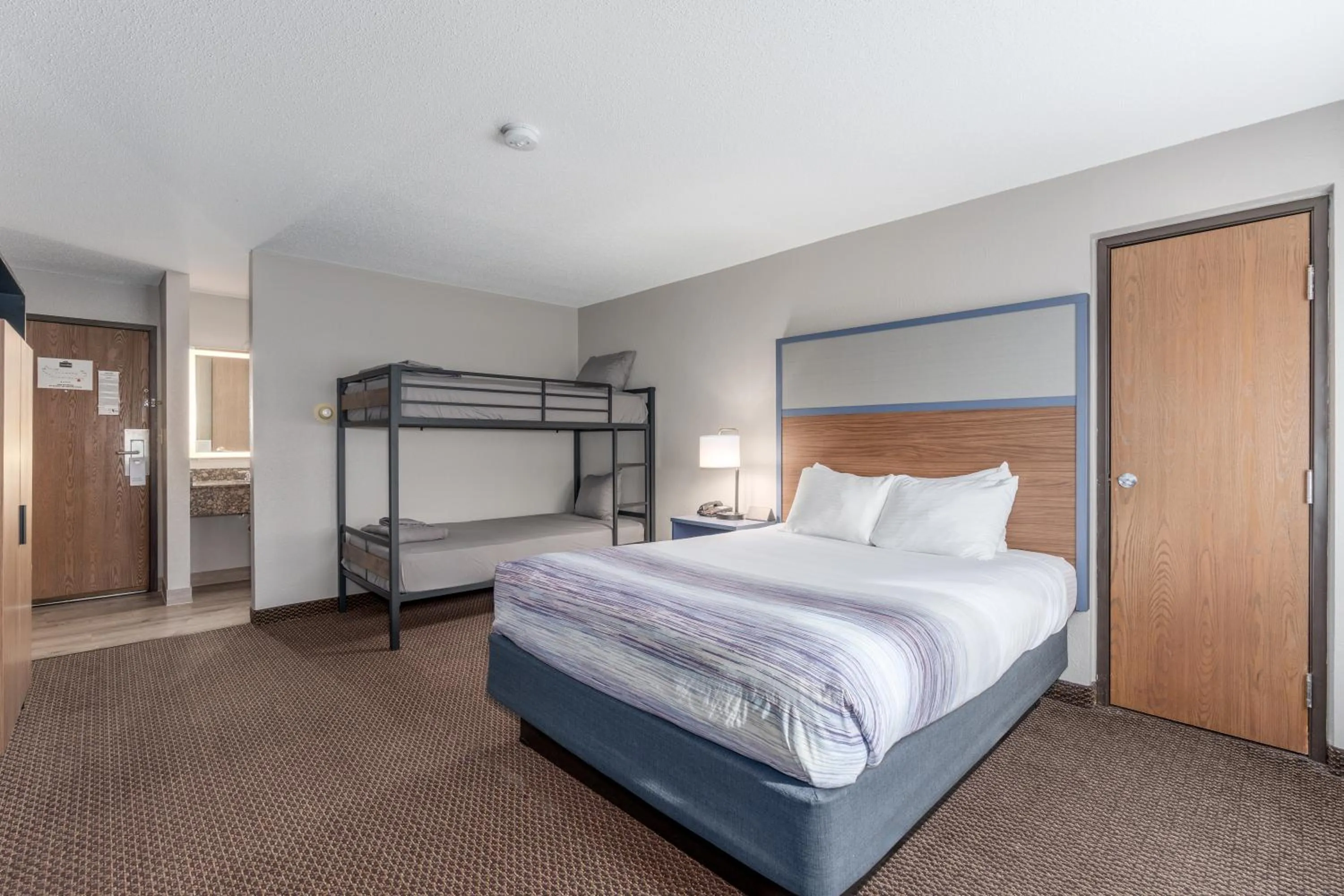 Bed in AmericInn by Wyndham New Richmond