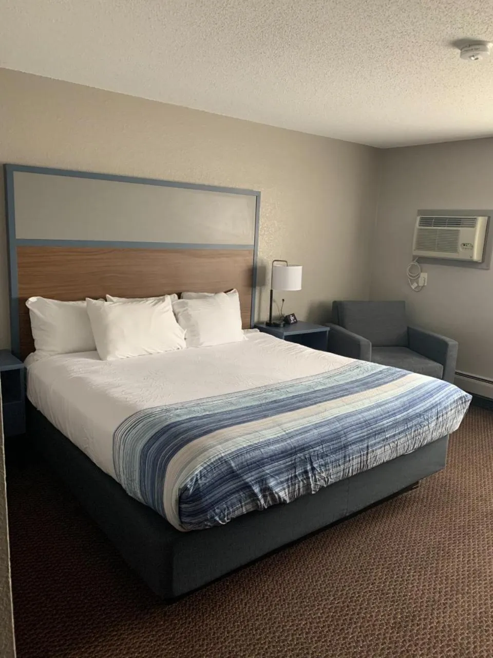 Bed in AmericInn by Wyndham New Richmond