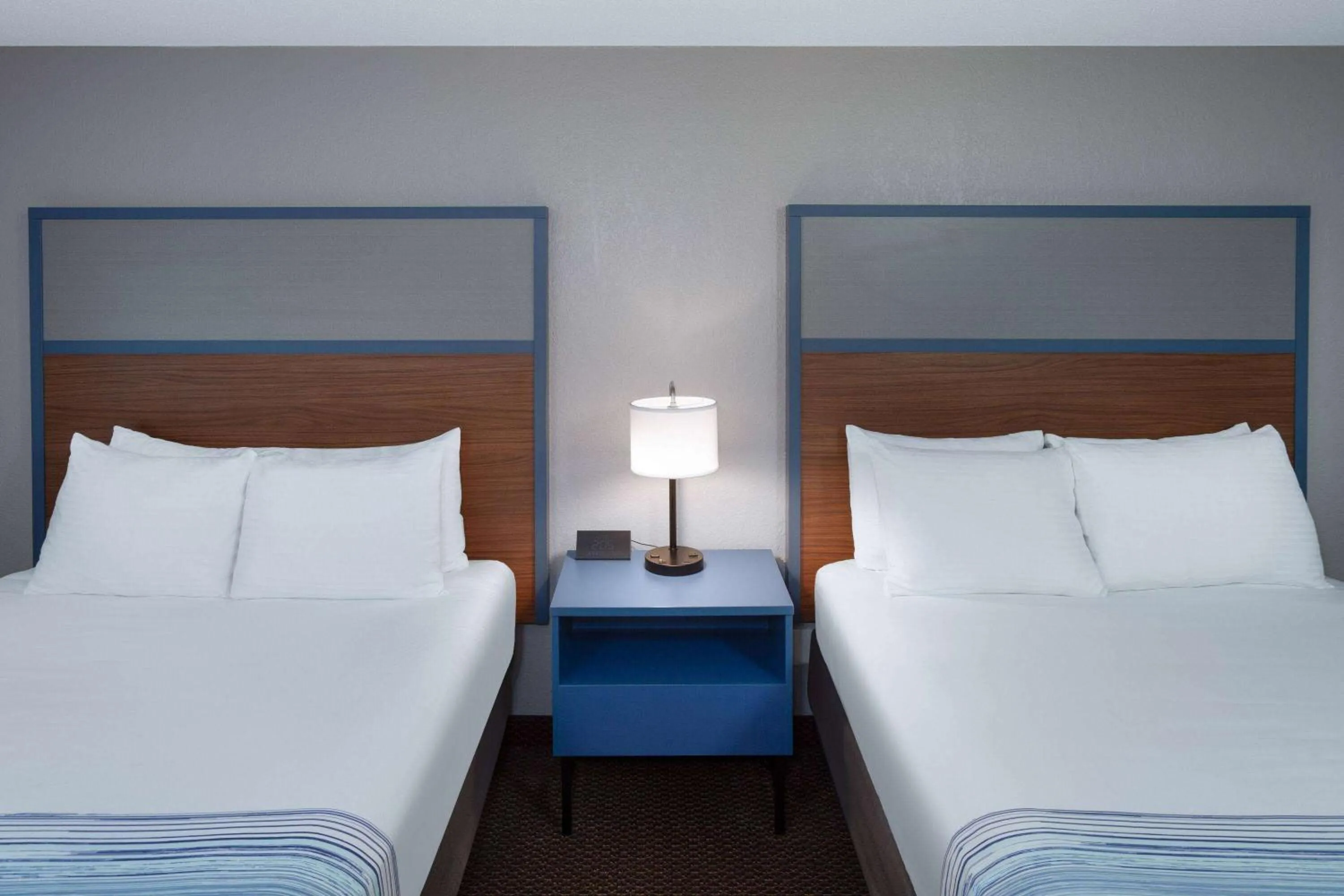 Bed in AmericInn by Wyndham New Richmond