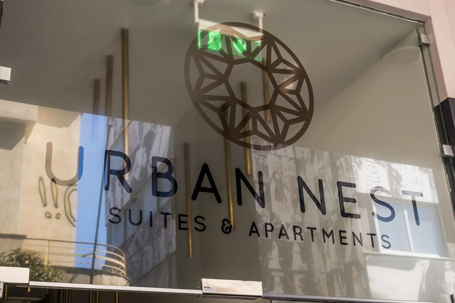 Property logo or sign in Urban Nest - Suites & Apartments